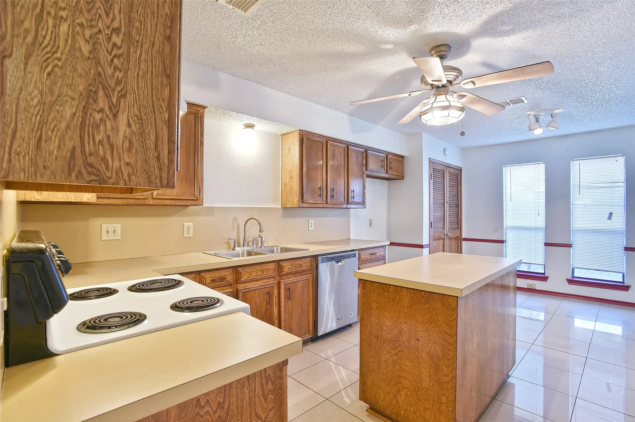 View of the kitchen and dining area from the main hallway.  The doors off the dining area lead to the large pantry and utility room.
