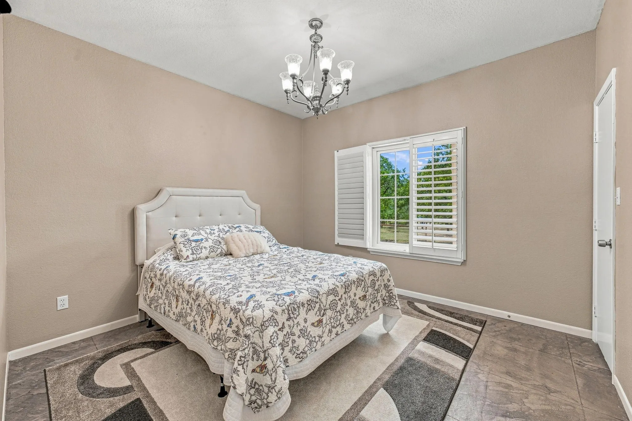Bedroom with custom walk-in closet. View to back of property