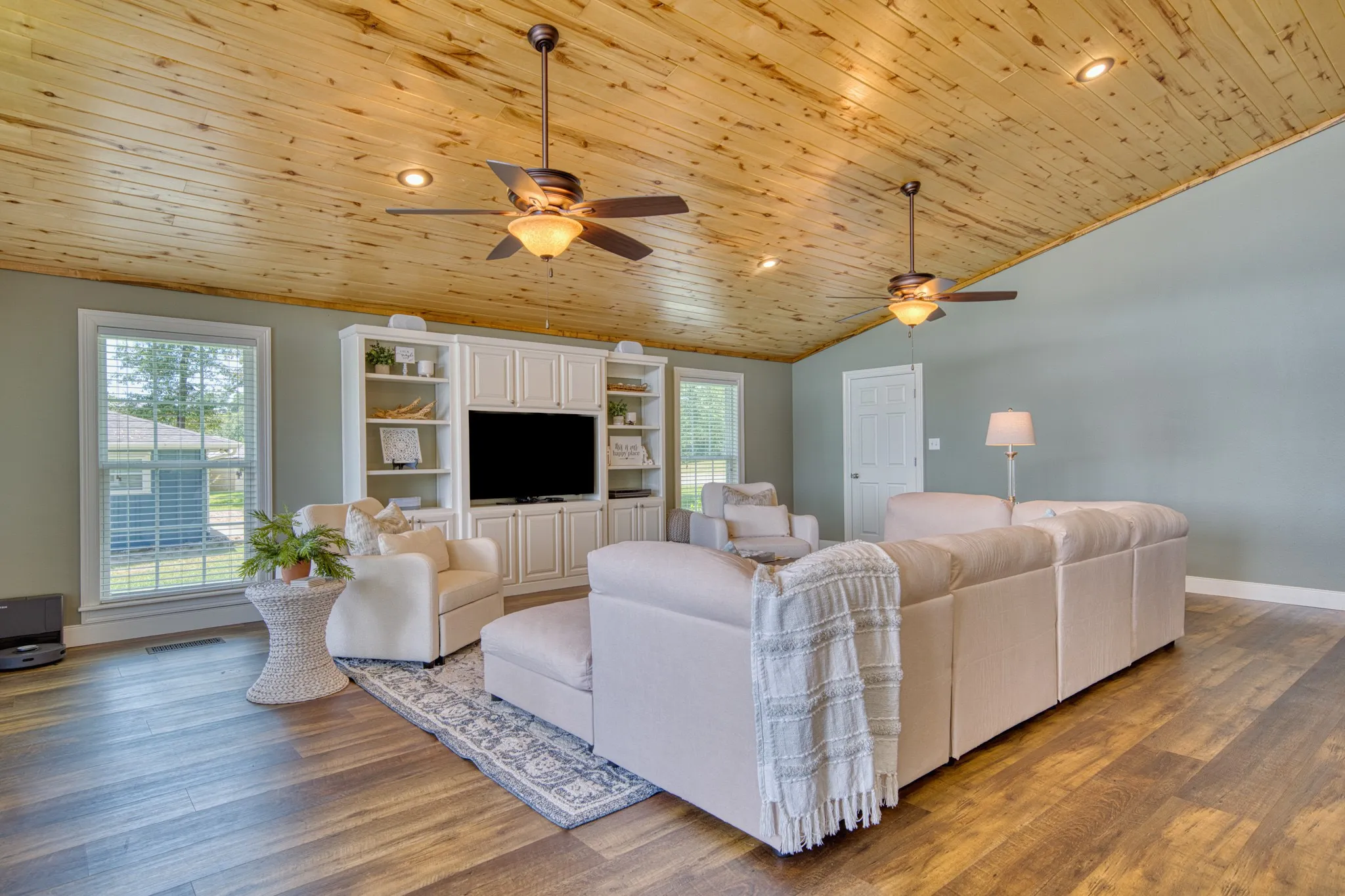 Wood-finish flooring with a vaulted wood-paneled ceiling