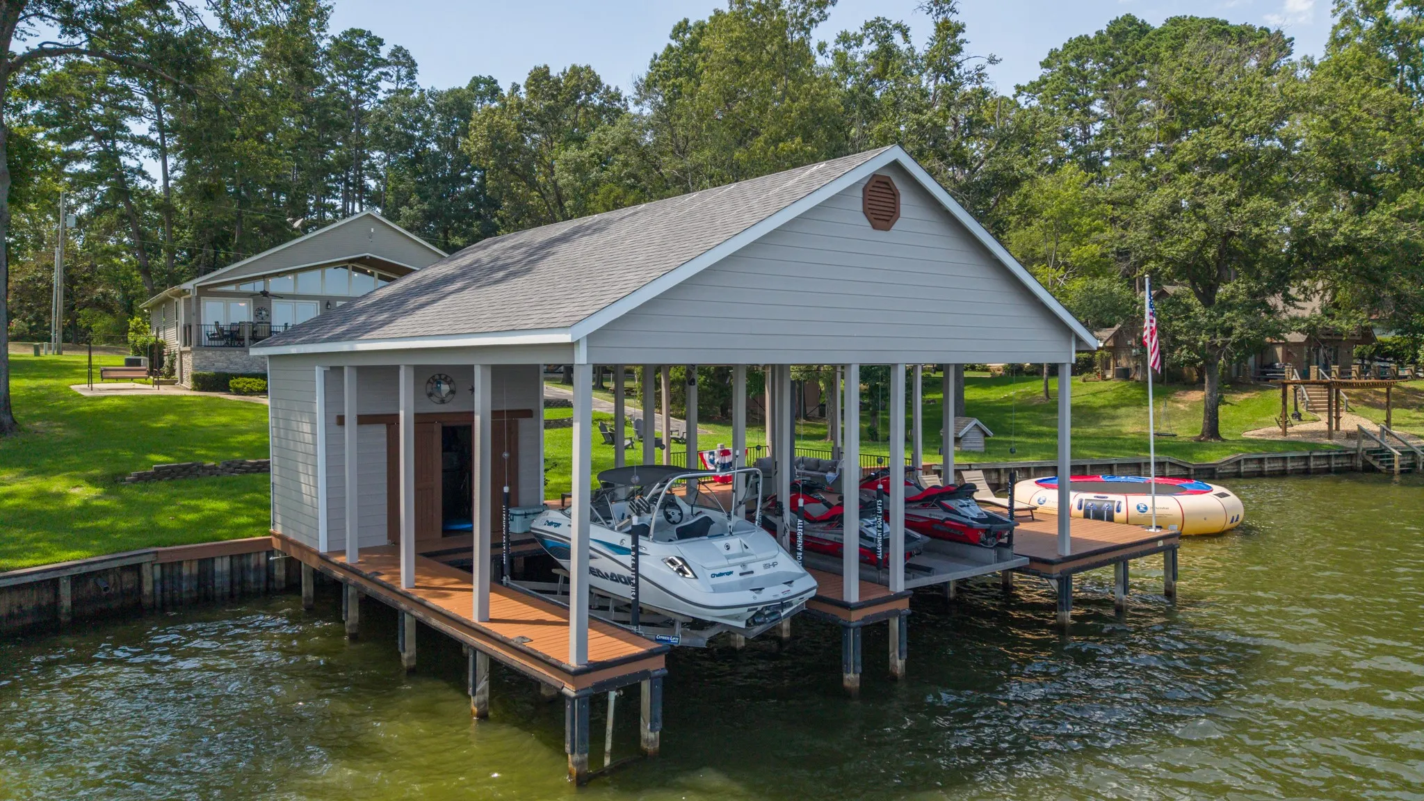 Covered boat dock with two boat lifts and additional open dock space