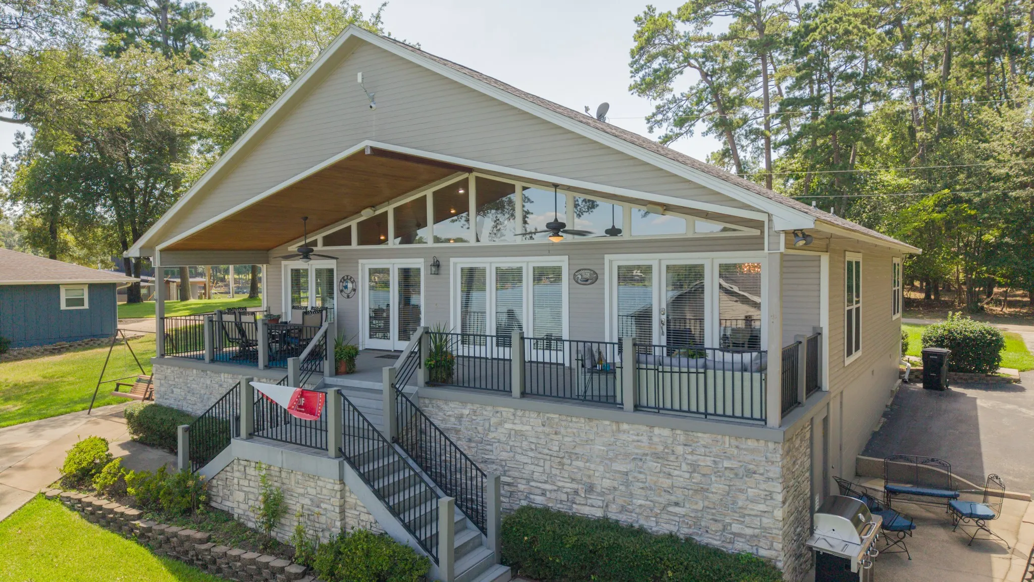 Multi-level exterior with stone veneer foundation and siding