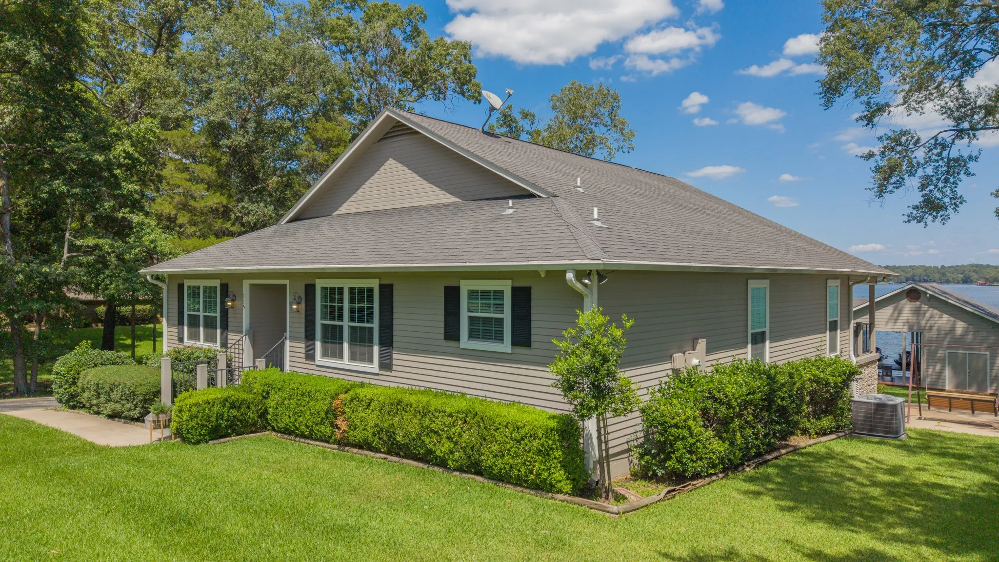 Single-story property featuring horizontal siding, a gabled roof, and dark shutters