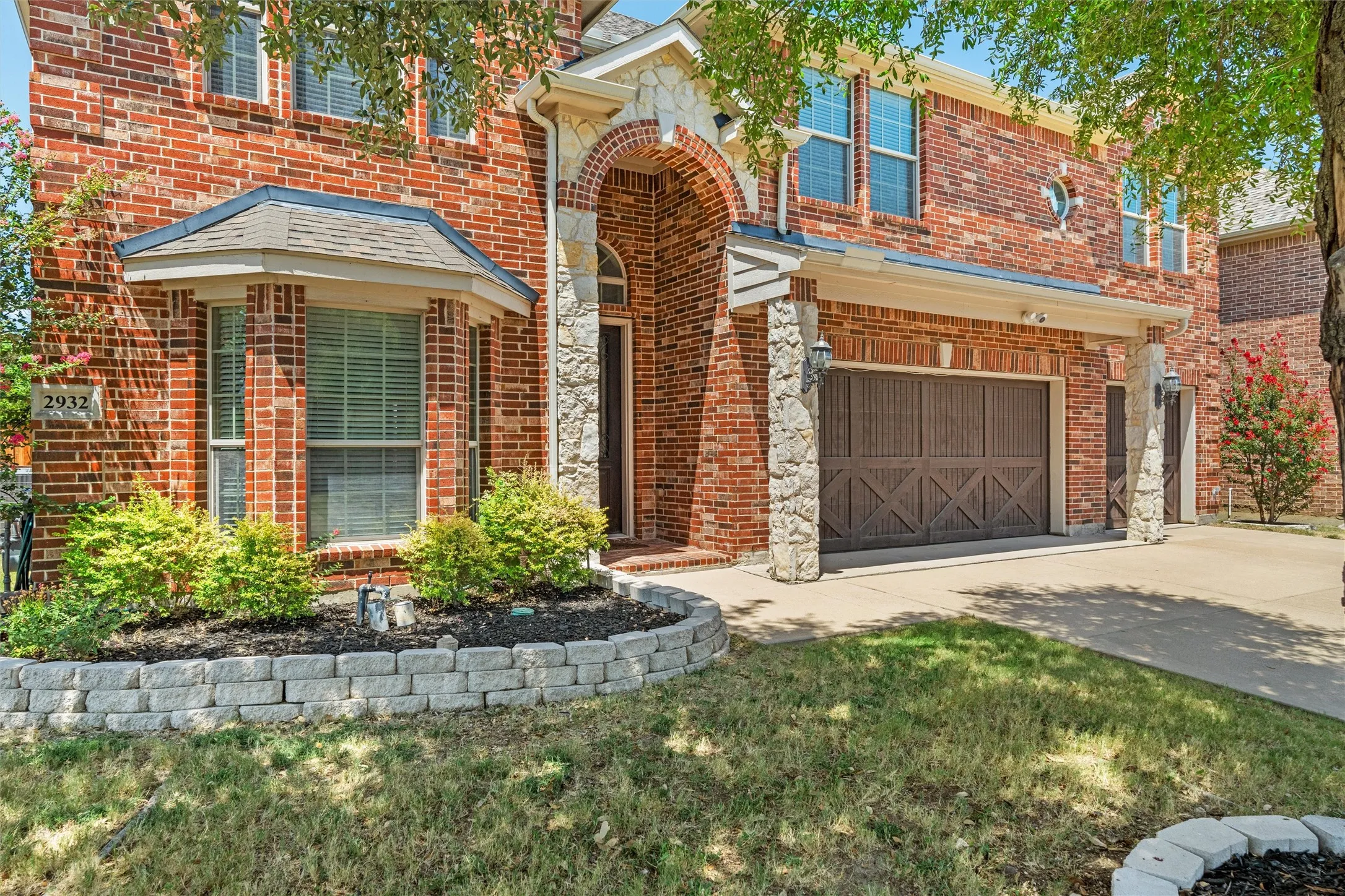 Brick exterior with stone accents and an arched entry