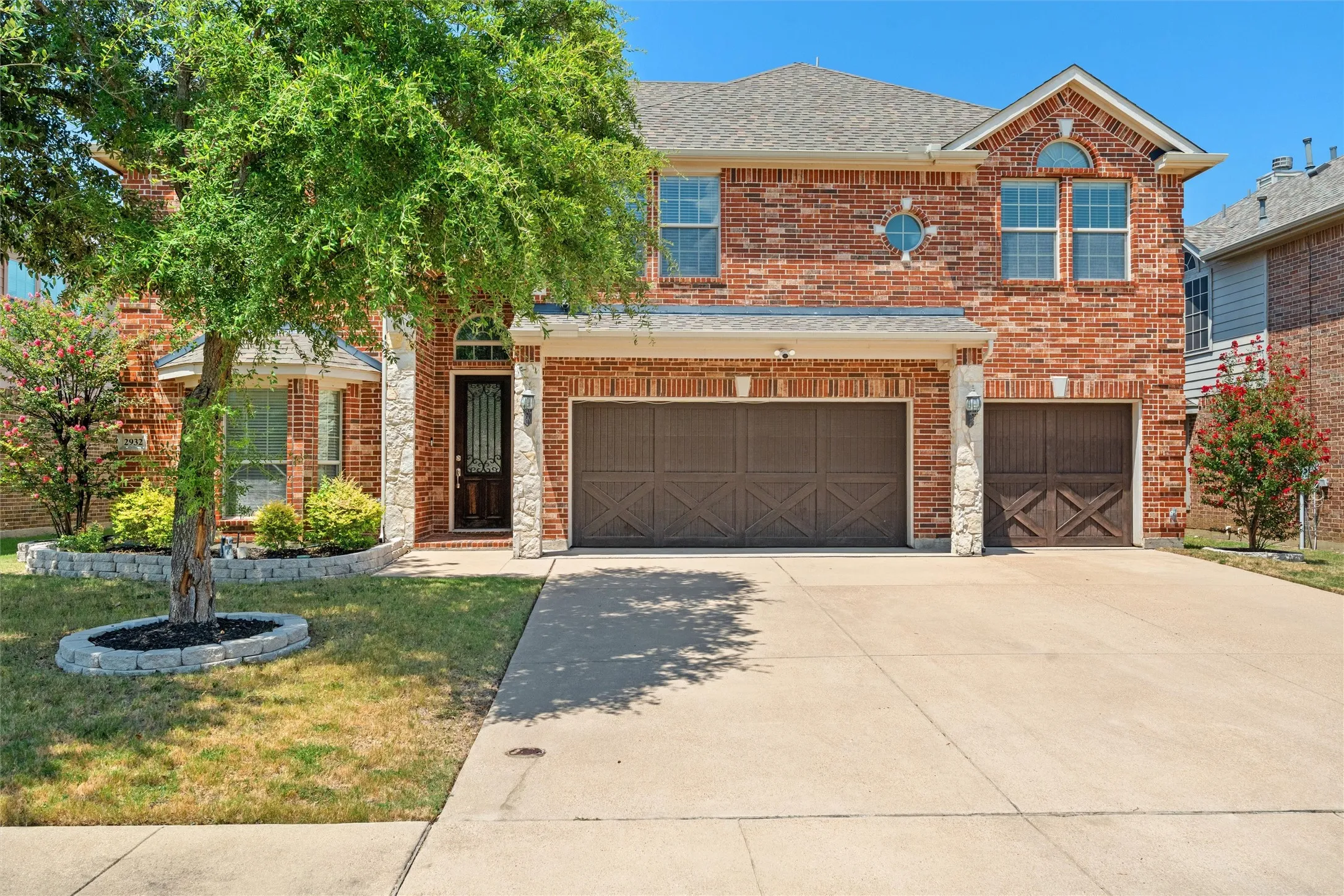 Brick exterior with stone accents and a gabled roof