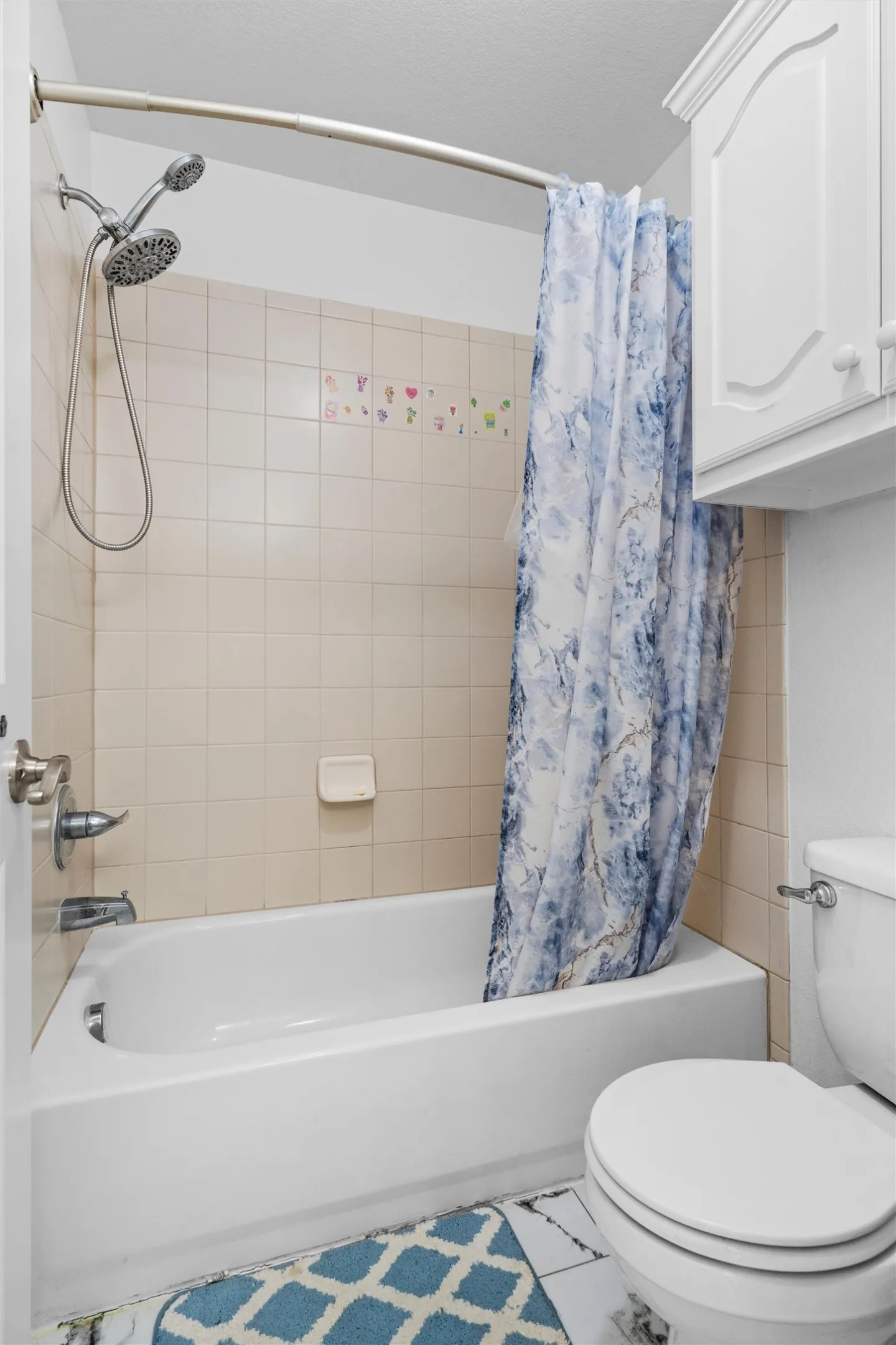 Tub and shower combination with a dual shower head and beige tile surround