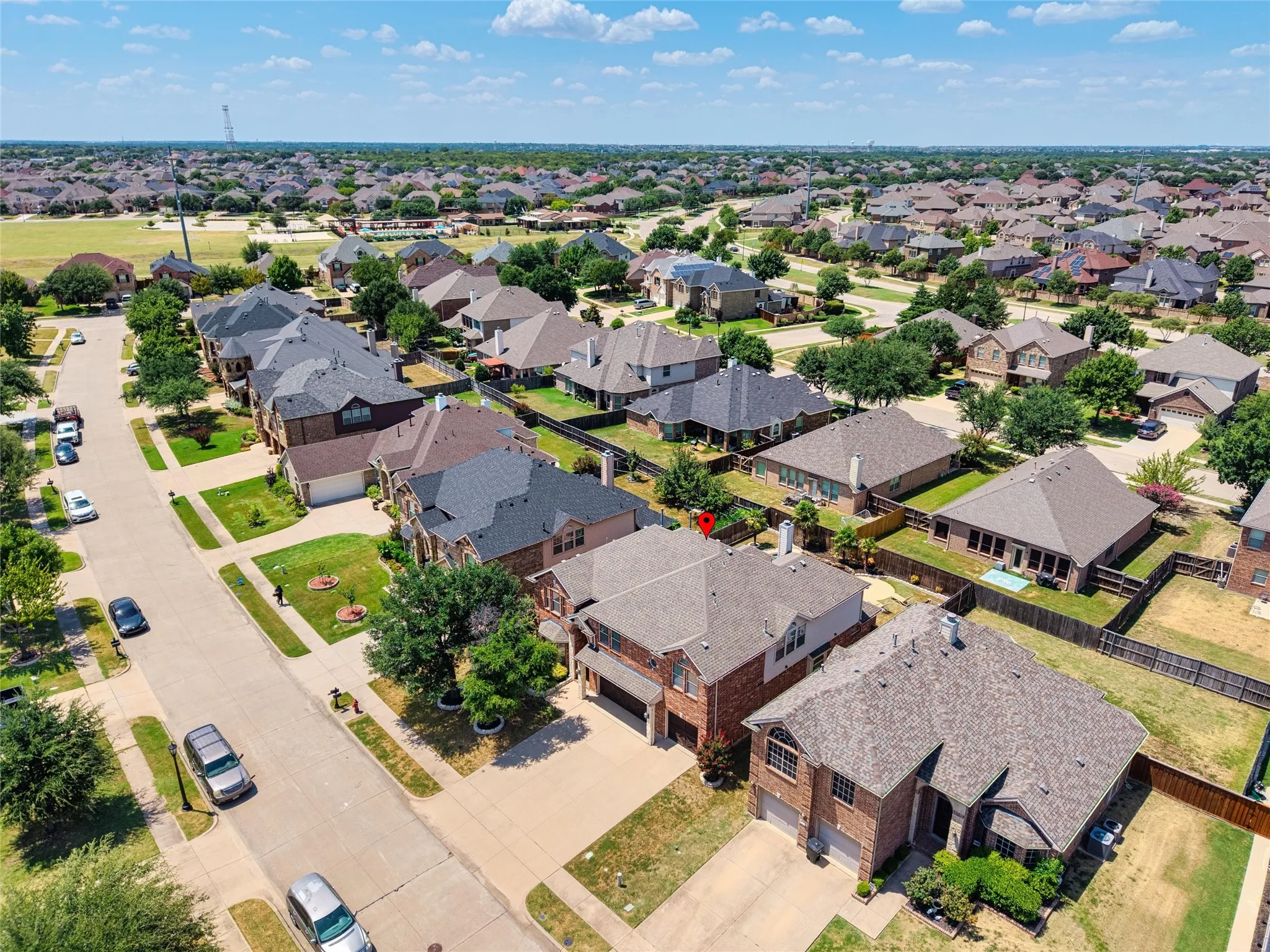 Aerial perspective showcasing a residential neighborhood with numerous detached homes, each featuring individual driveways