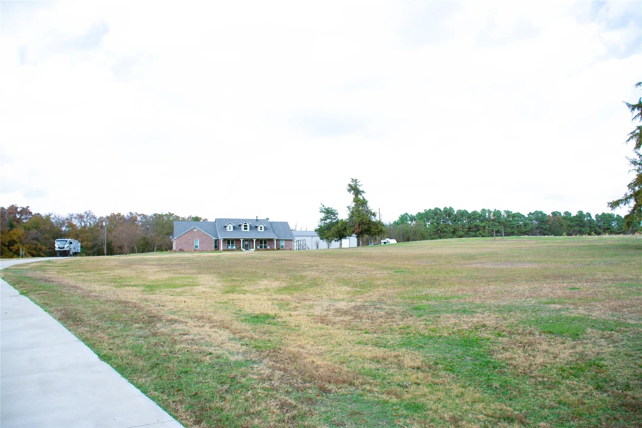 Front lawn, concrete driveway, RV hookup