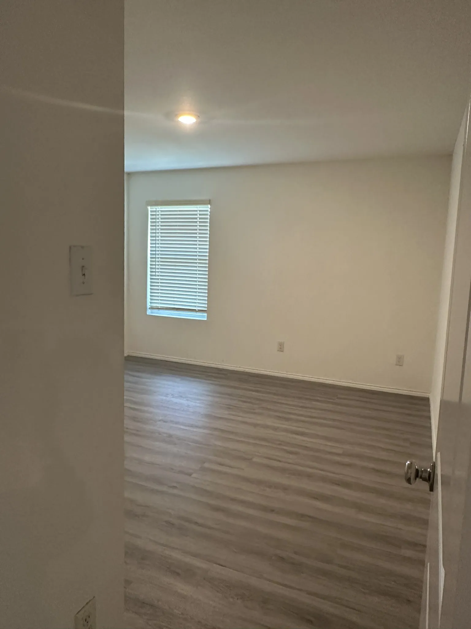 Empty room featuring wood finished floors and baseboards