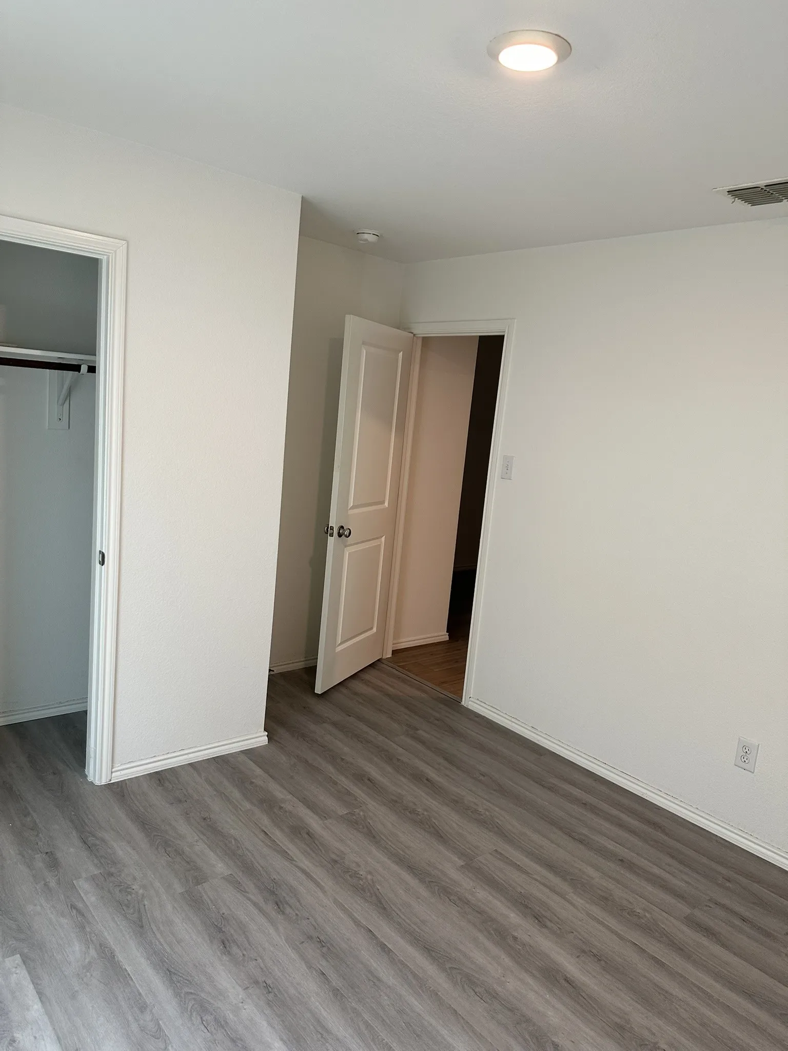 Unfurnished bedroom with wood finished floors