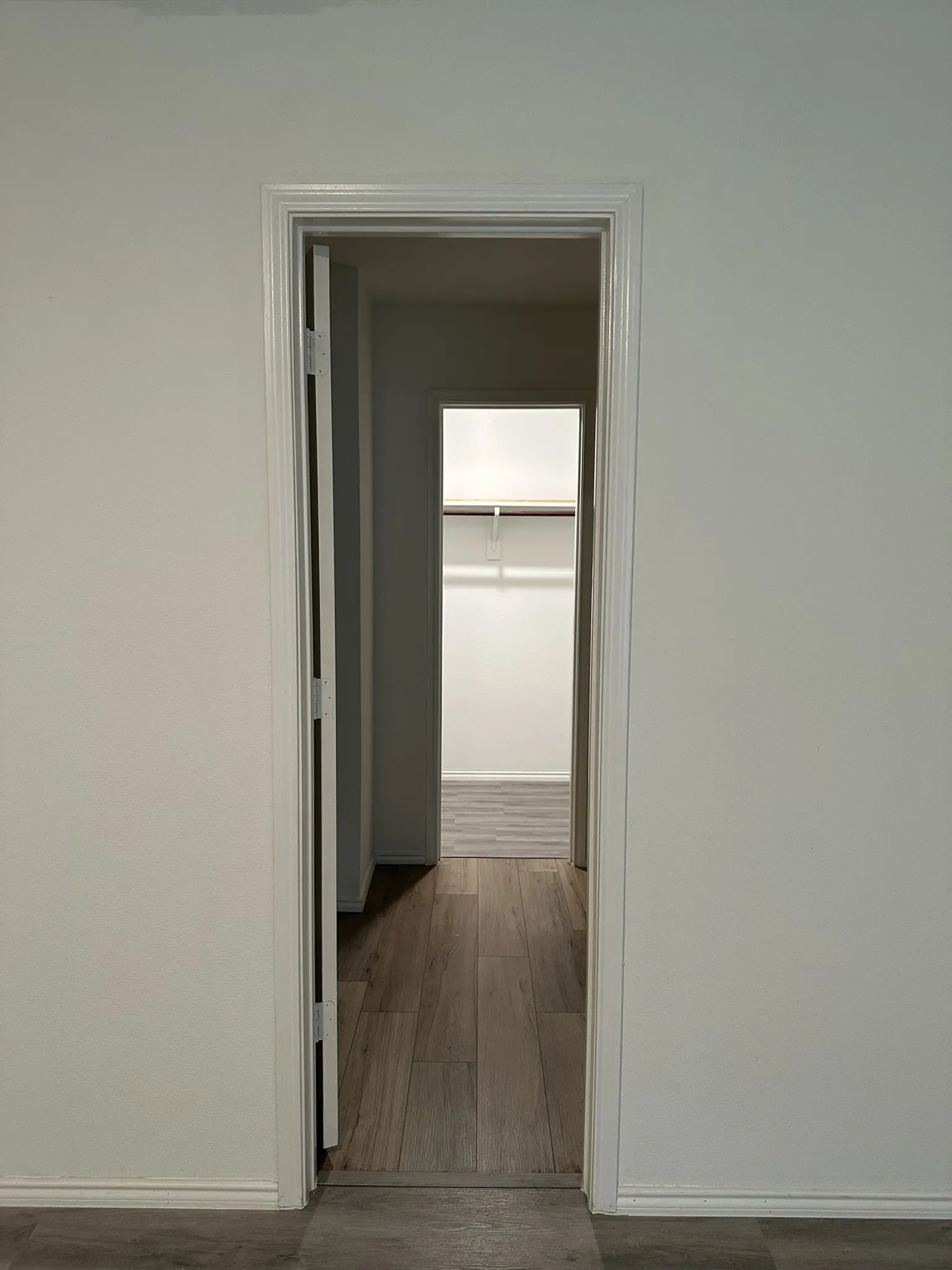 Corridor with wood finished floors and baseboards
