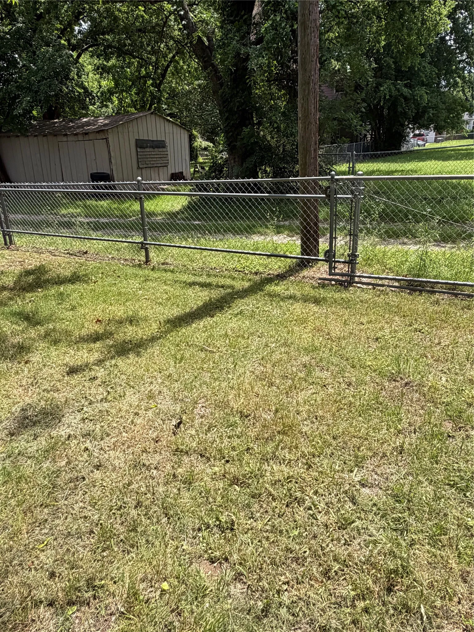 Chain-link fencing with a sliding gate