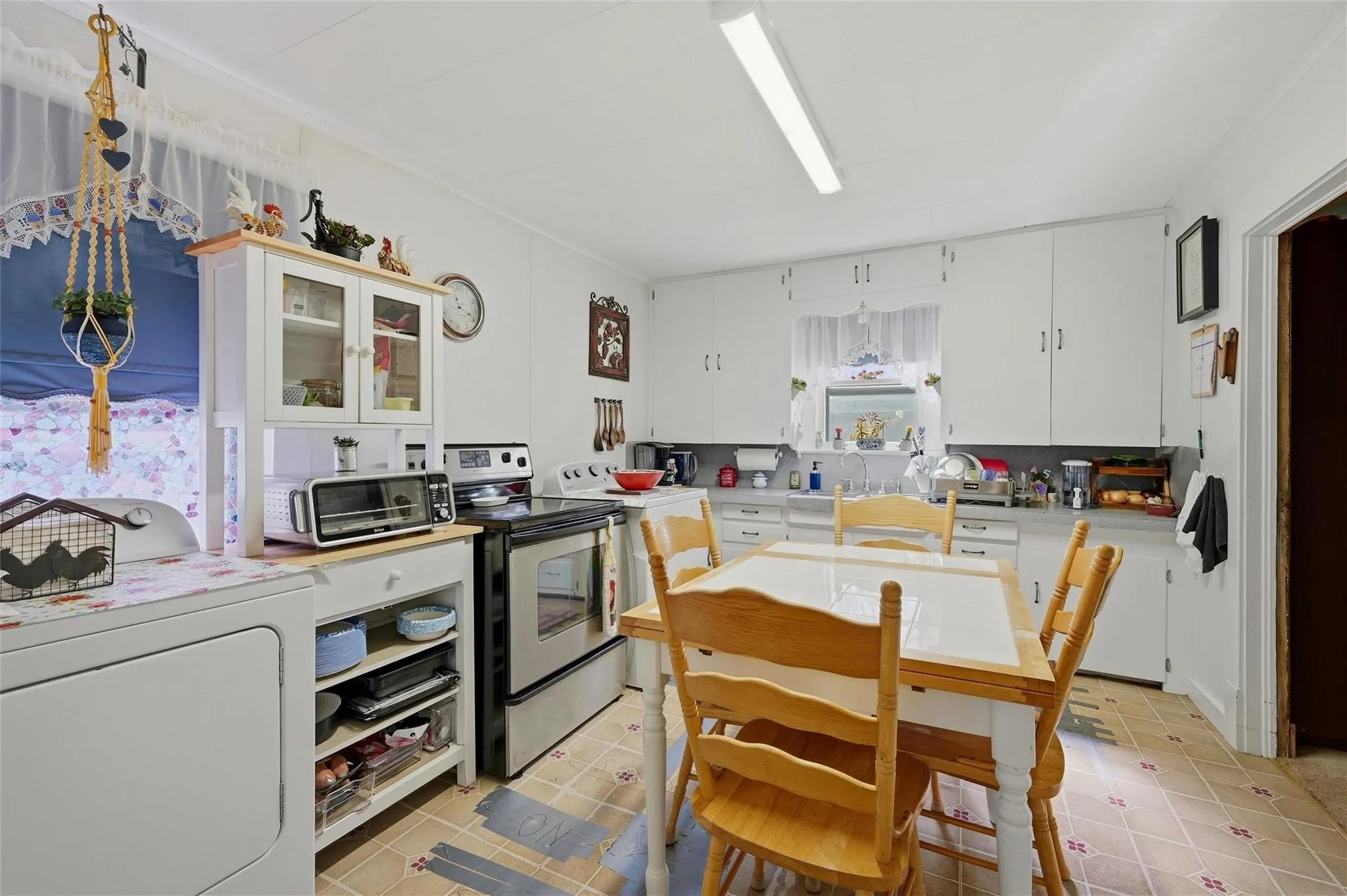 Kitchen featuring white cabinetry and a built-in oven range