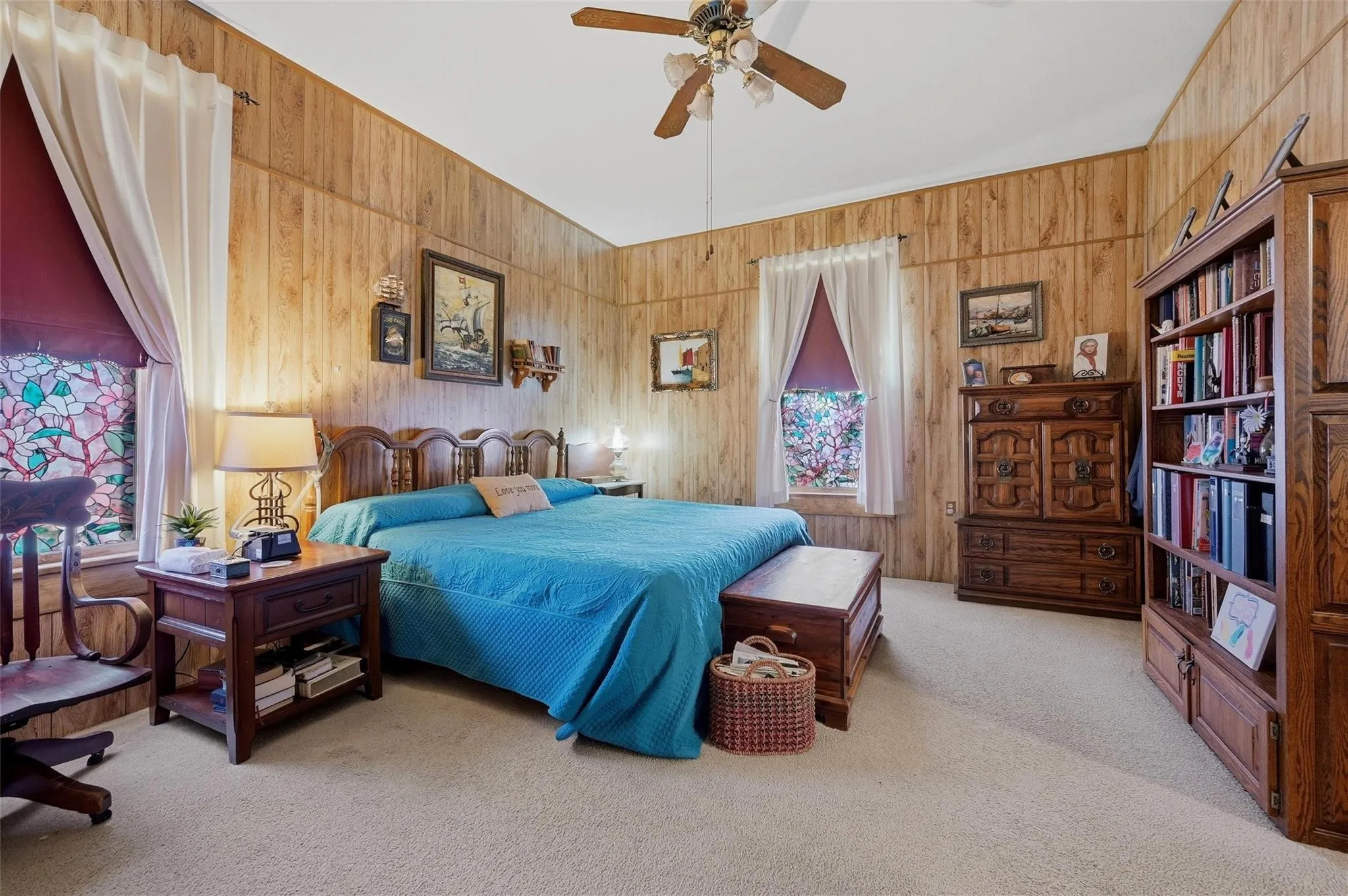 Wood-paneled walls with decorative trim and soft carpeting