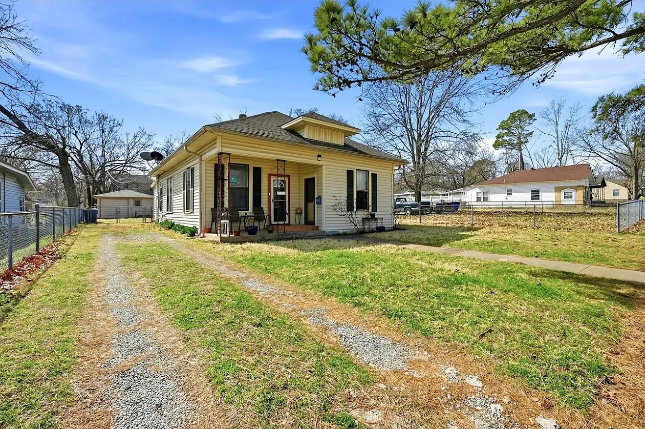 Single-story residence on 2 lots with detached garage and workshop