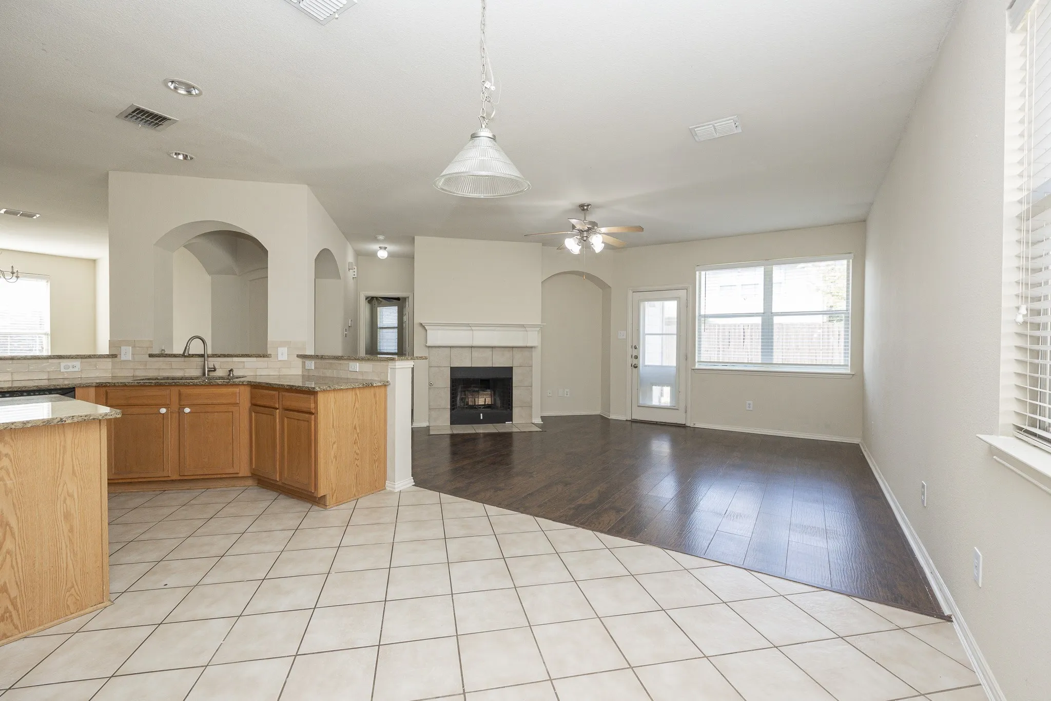 Kitchen featuring wood cabinetry, granite countertops, and tile flooring