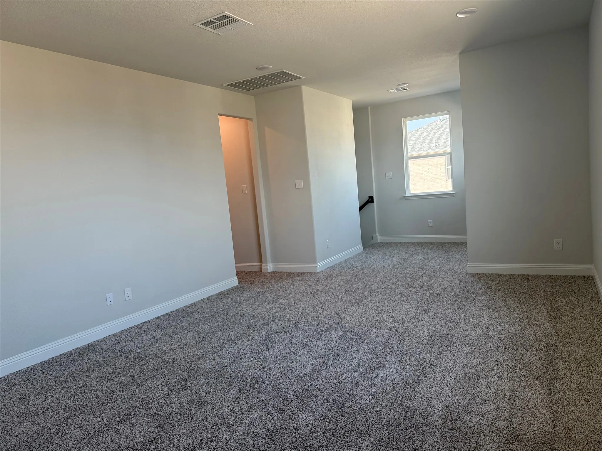 Neutral wall paint, recessed lighting, window with a sill, grey carpet flooring, and white trim