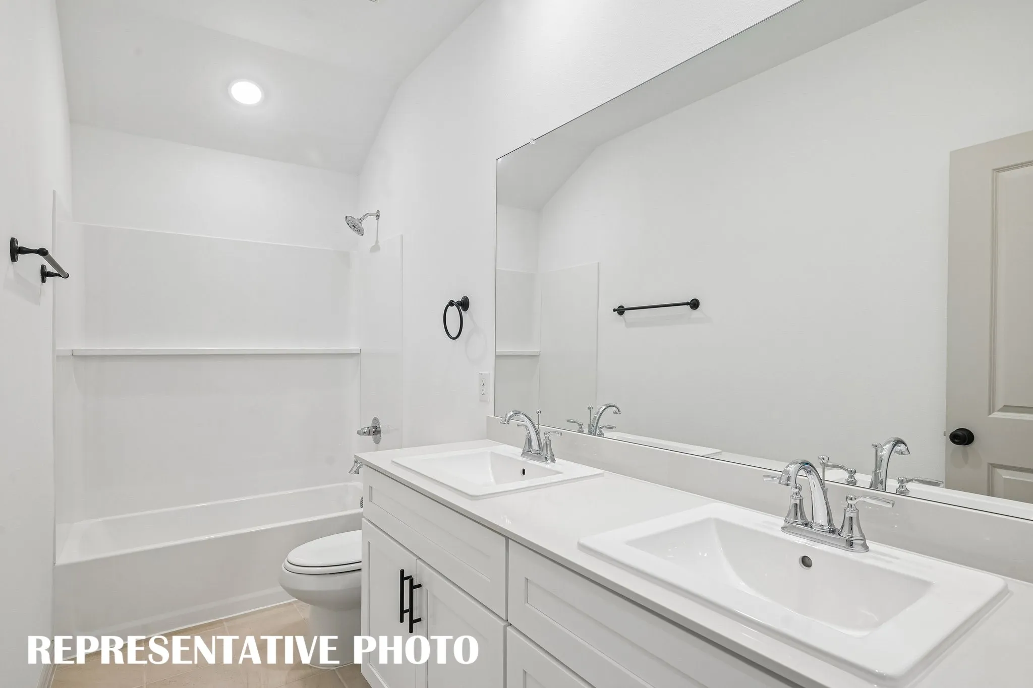 Guests will enjoy their own vanity space in this lovely guest bath built for two!  REPRESENTATIVE PHOTO