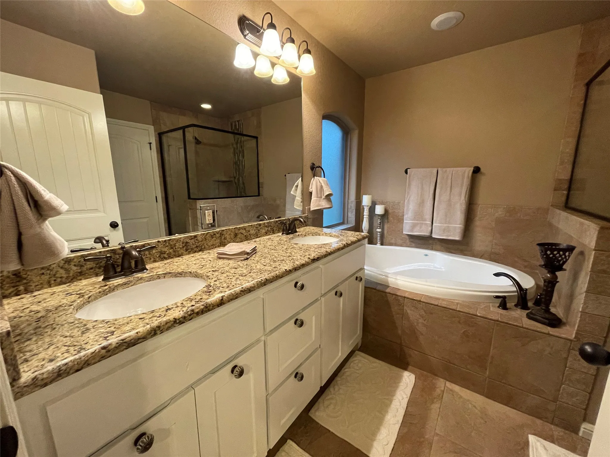 Dual vanity with a stone countertop and undermount sinks
