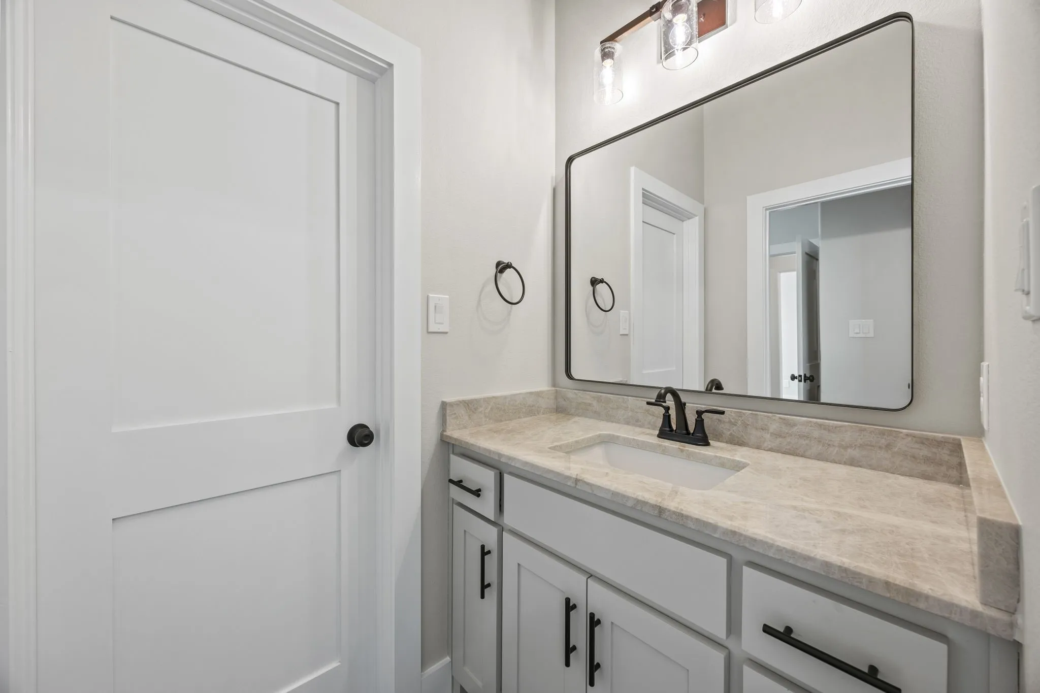 White paneled door with matte black hardware