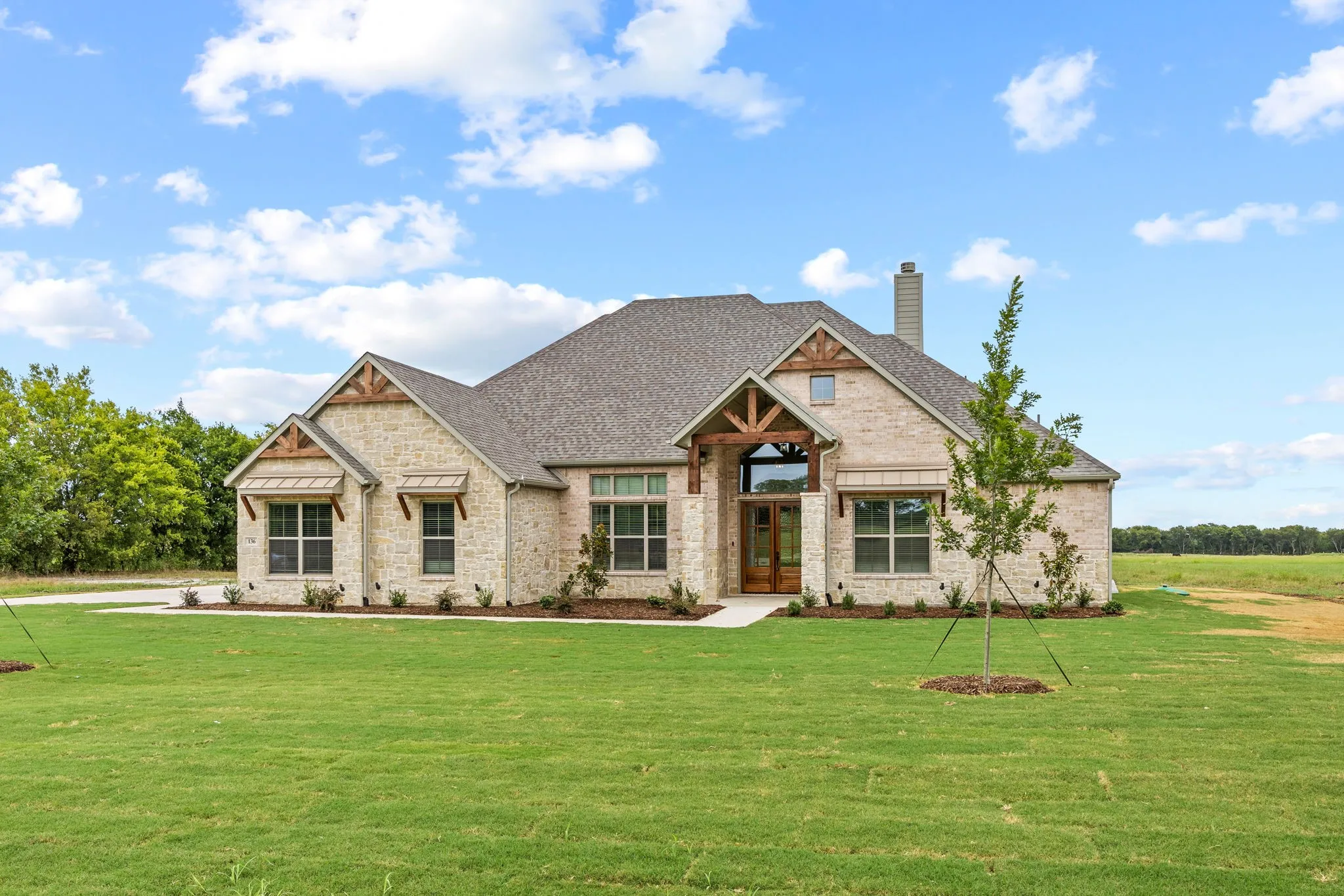 Stone veneer exterior with wood beam accents