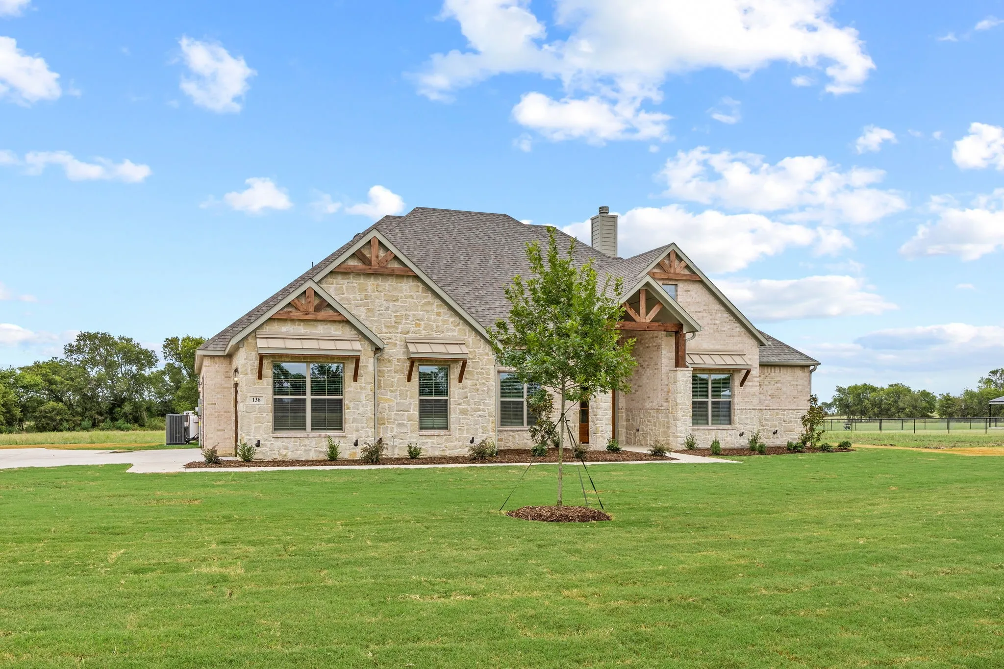 Stone veneer exterior with wood-beam accents and gable details