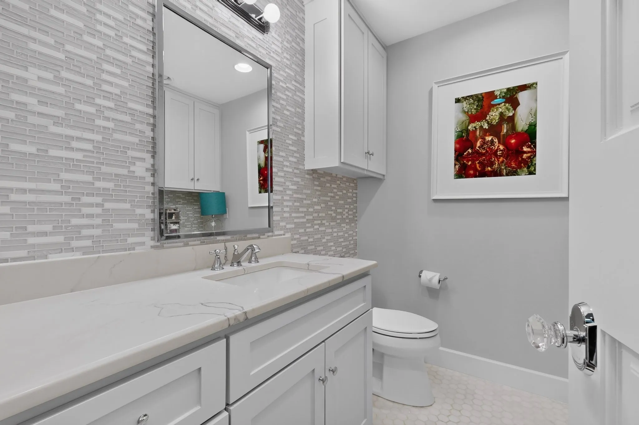 Vanity with a rectangular undermount sink, a chrome faucet, and a quartz countertop