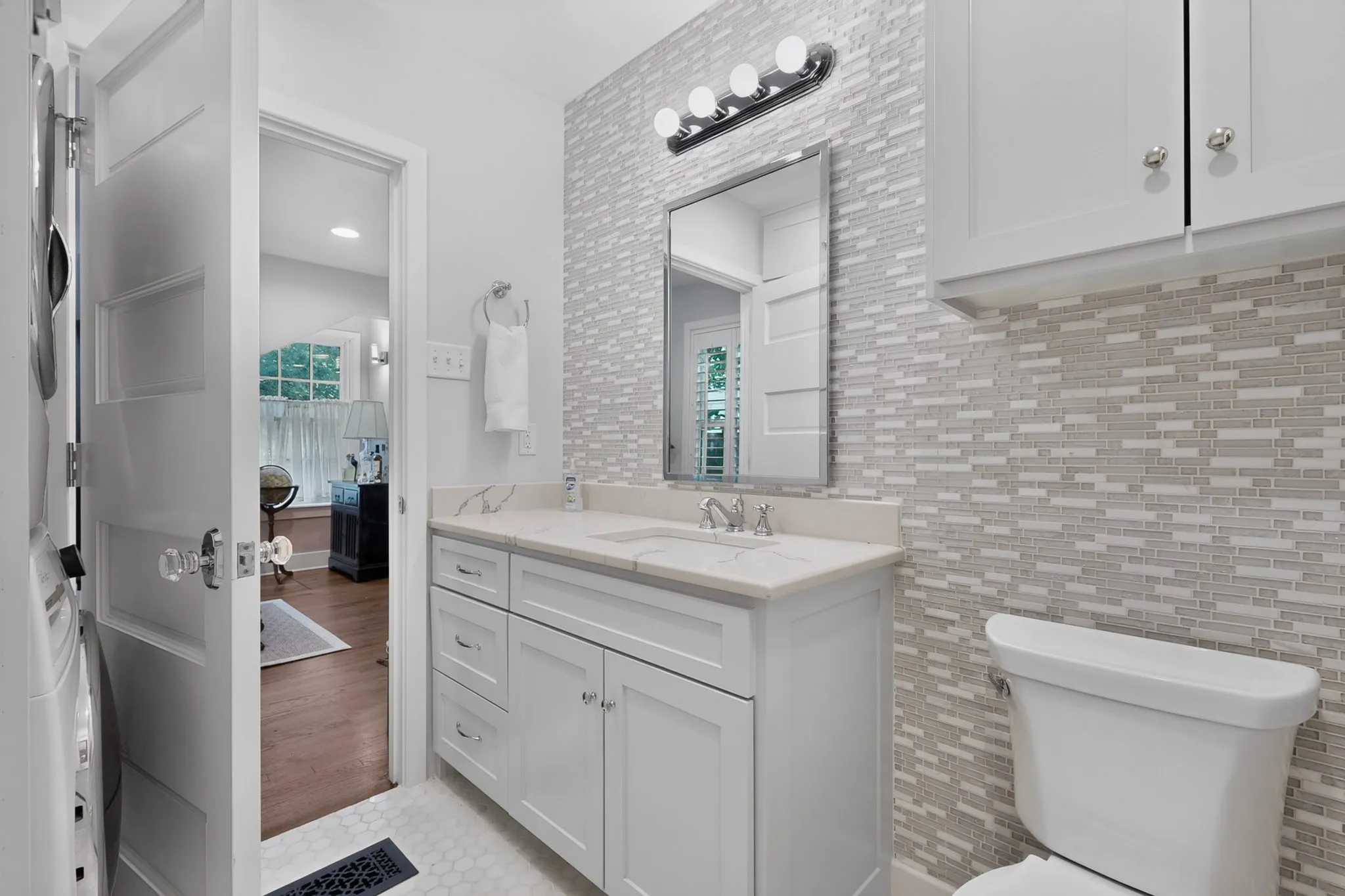 Vanity with a single basin, undermount sink, and white cabinetry