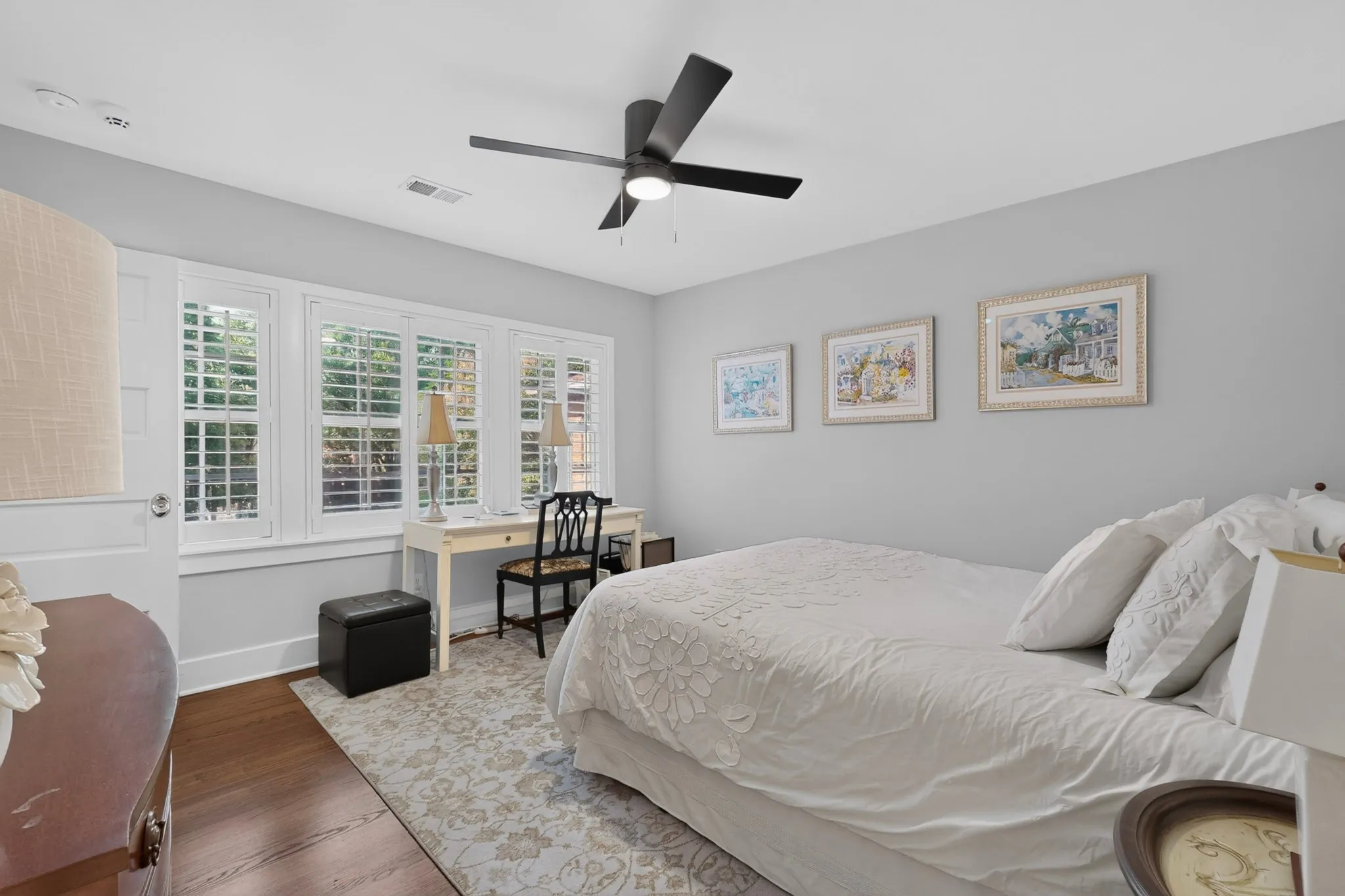 Recessed lighting and a ceiling fan fixture, wood-finish flooring, and white window shutters