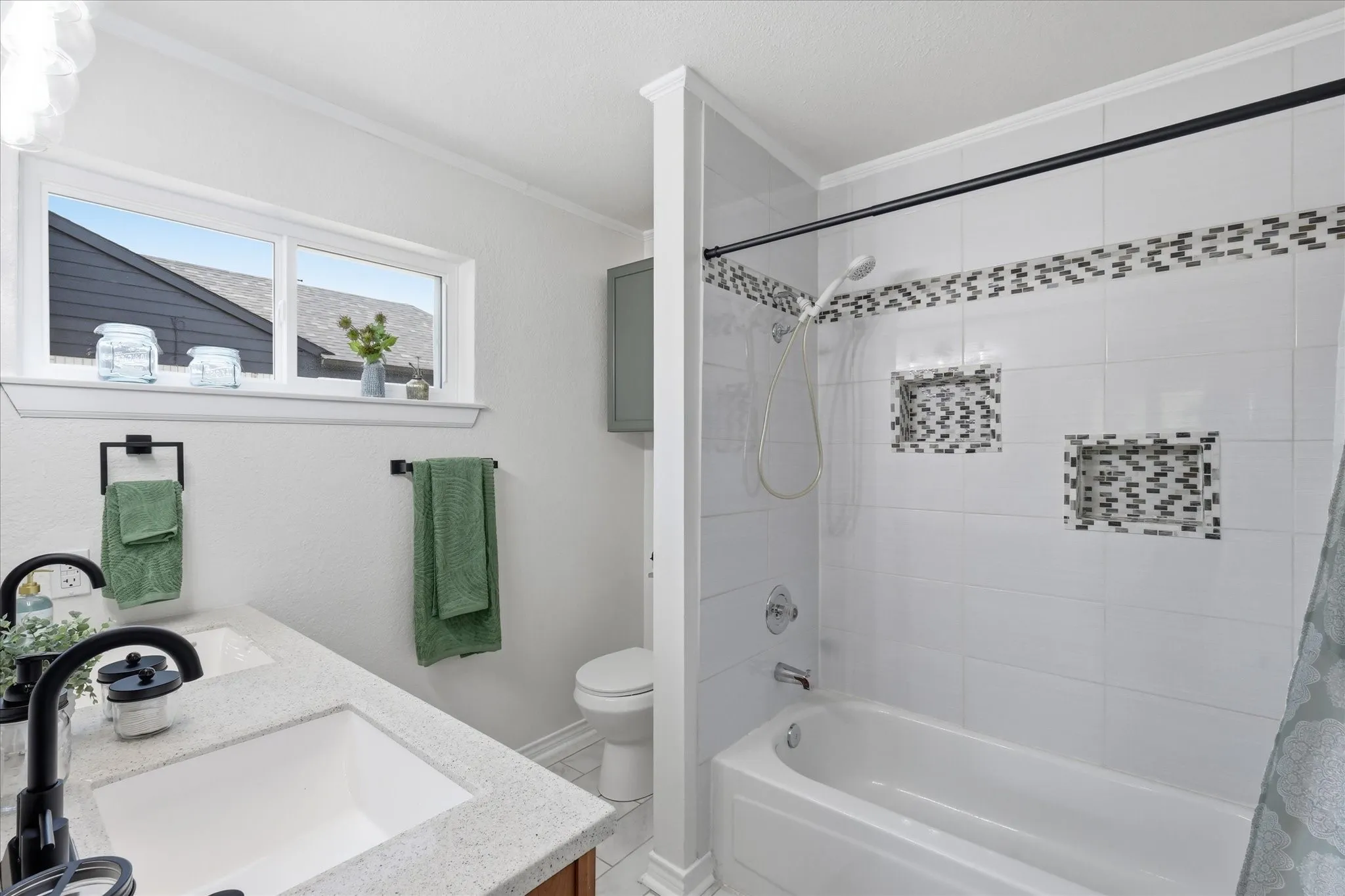 Dual-sink vanity with light-toned countertop, black fixtures, and integrated storage