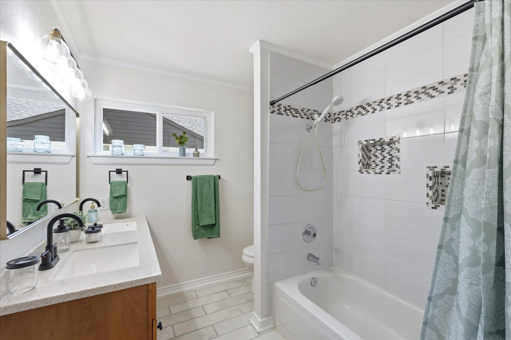 Bathroom featuring a single vanity with a white rectangular sink, wood-finish cabinetry, and a light-colored countertop