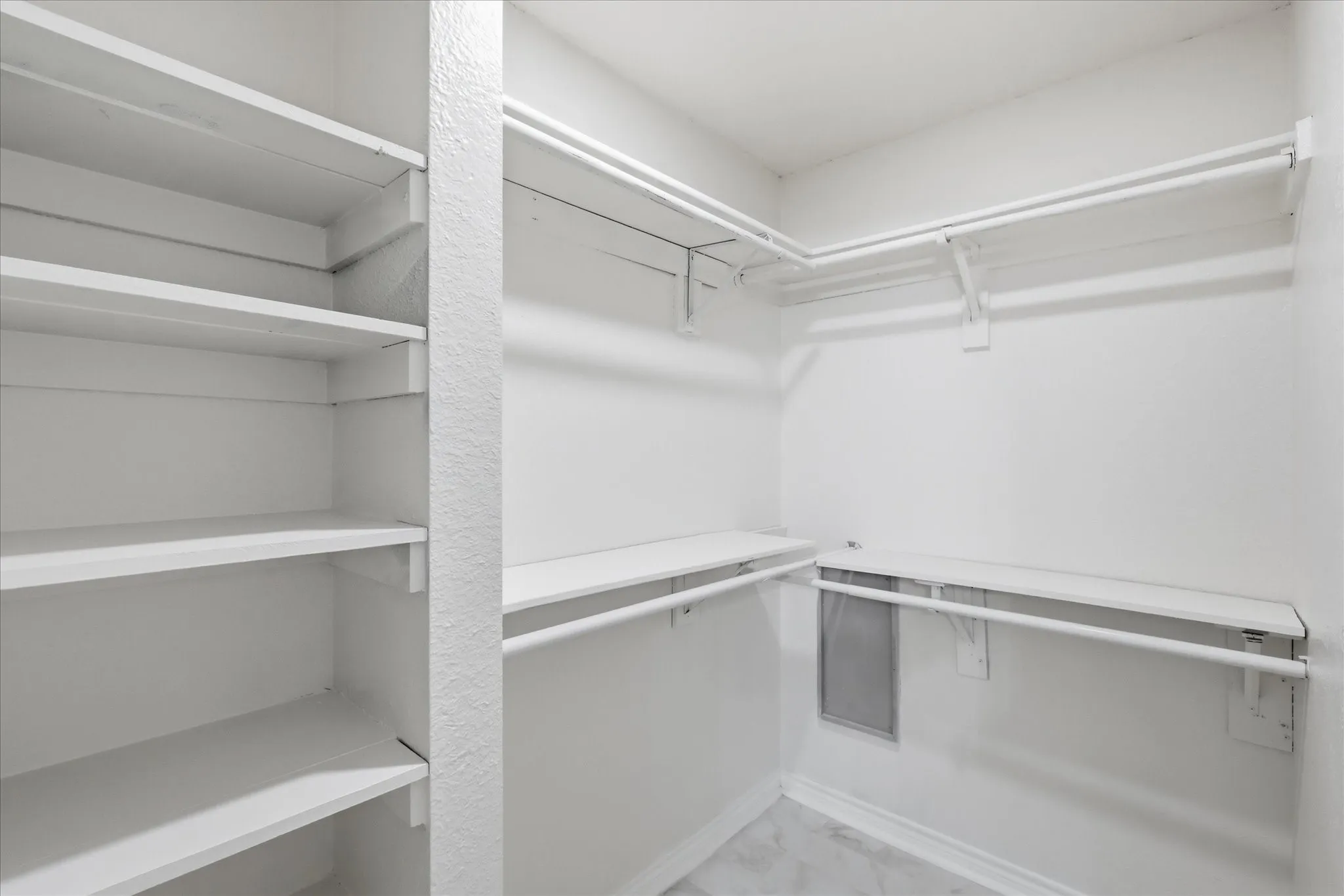 Integrated shelving system, multiple hanging rods, and light-toned flooring