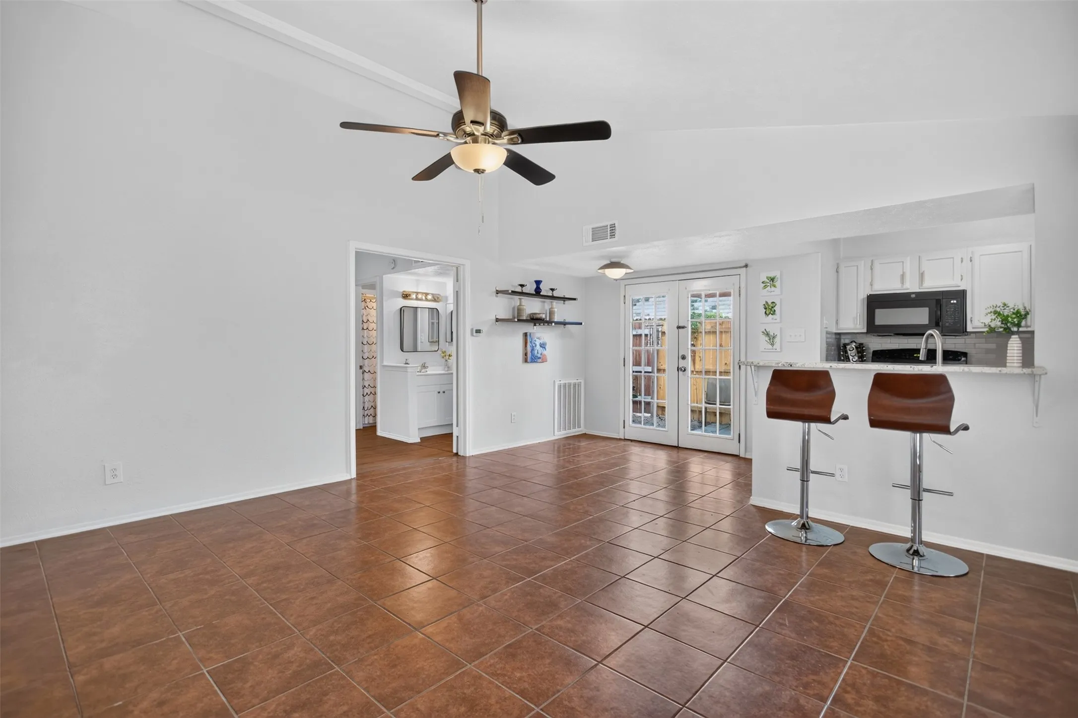 Living Area with Nice tile, Vaulted Ceiling and Ceiling Fan
