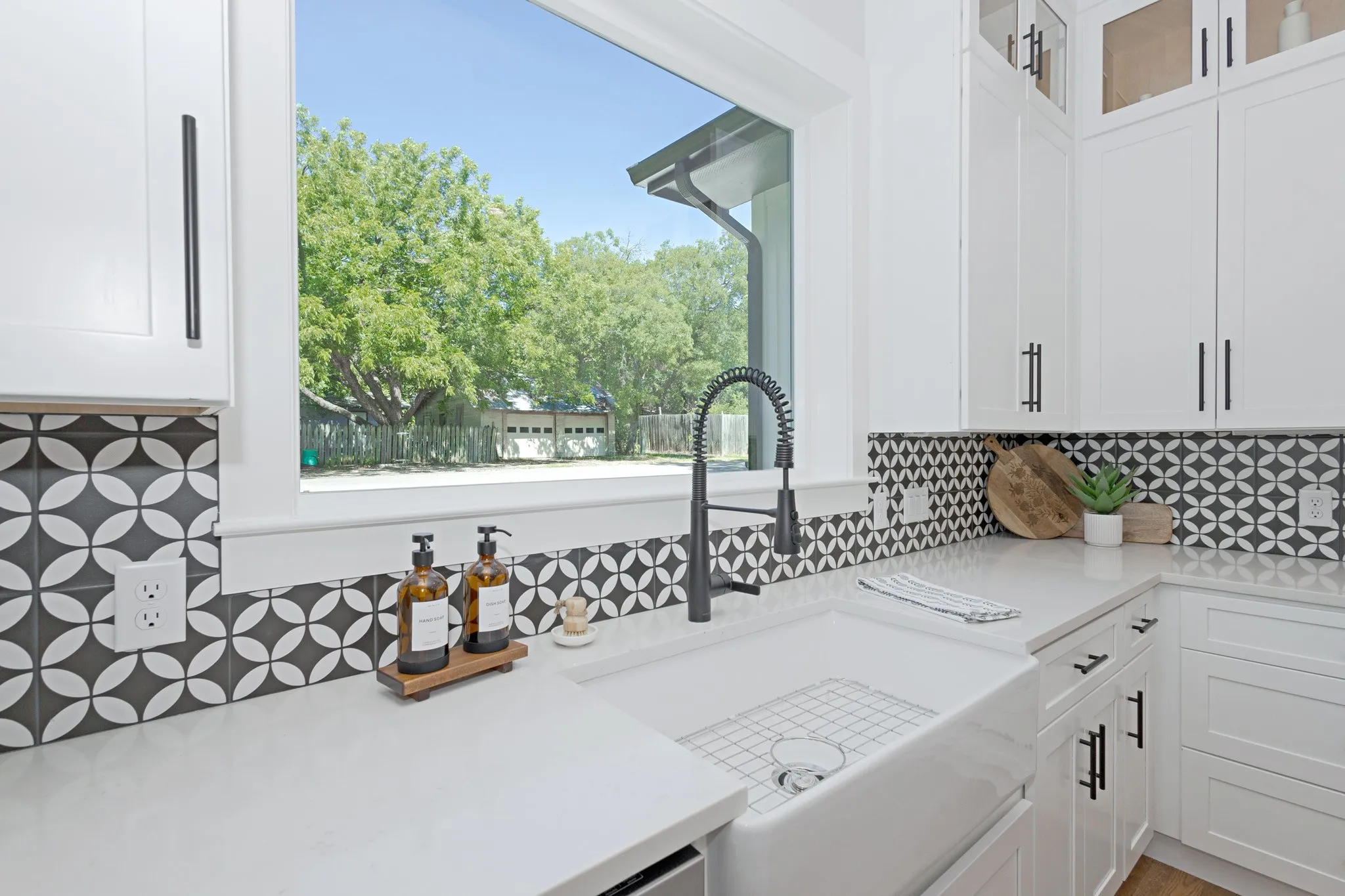 The Picturesque Window frames peaceful outdoor views as natural light fills the kitchen.