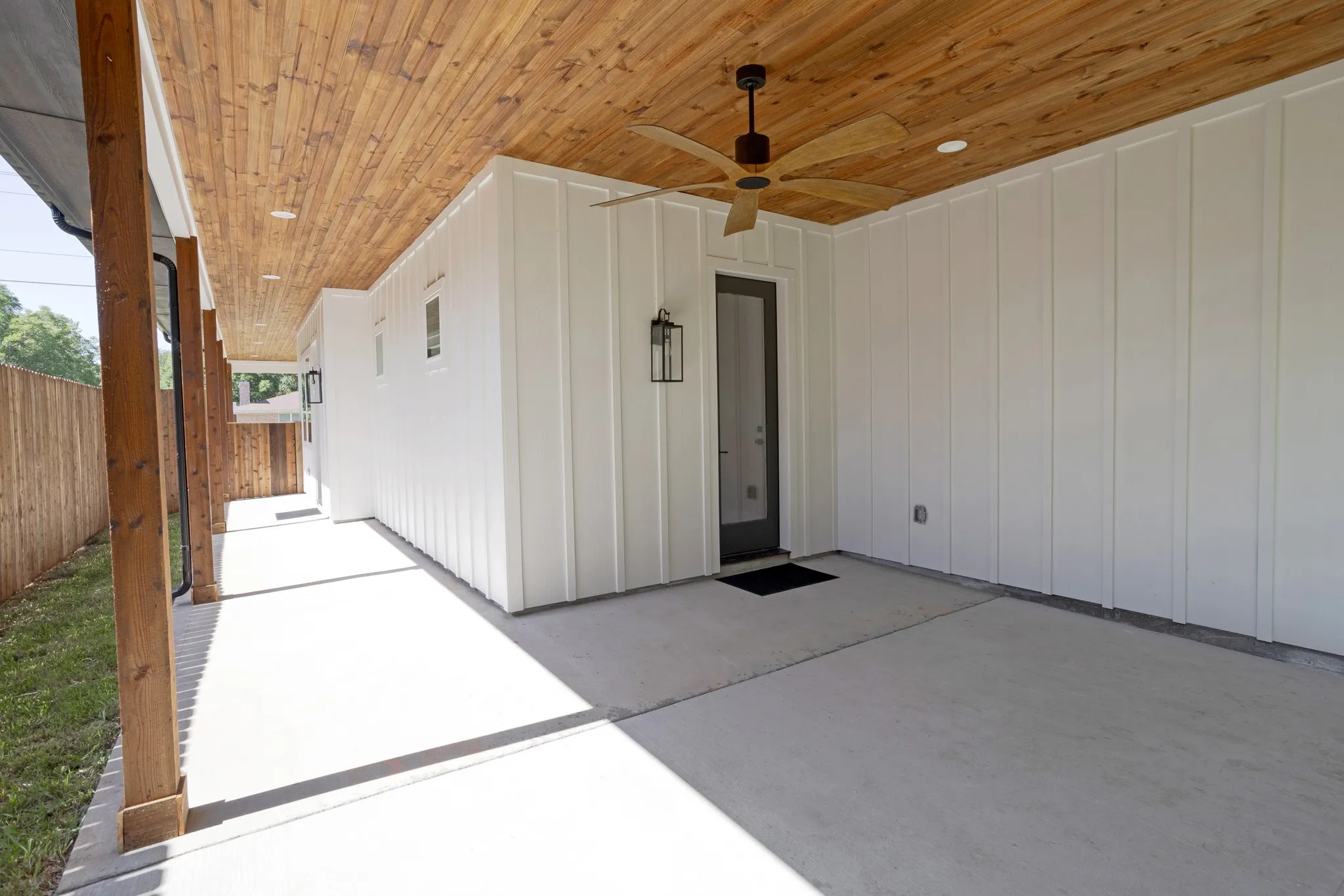 Expansive Covered Porch with Cedar Posts and a Stained Tongue-And-Groove Ceiling with an Outdoor Ceiling Fan is Plumbed for a Gas Grill and includes an outlet designated for your Outdoor TV and Dimmable Lighting.