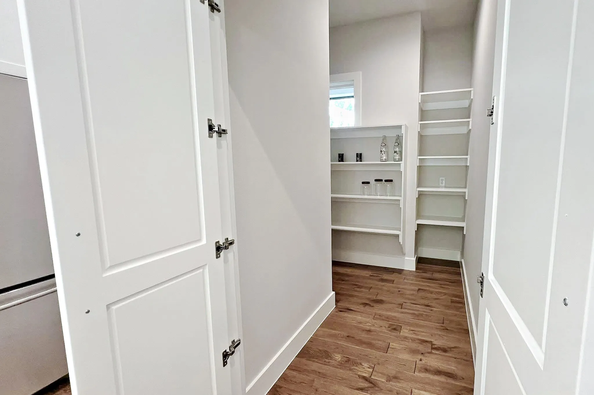 A spacious Walk-In Hidden Pantry keeps everything organized and within reach. There is plenty of storage space for all your kitchen essentials including an outlet for small appliances.