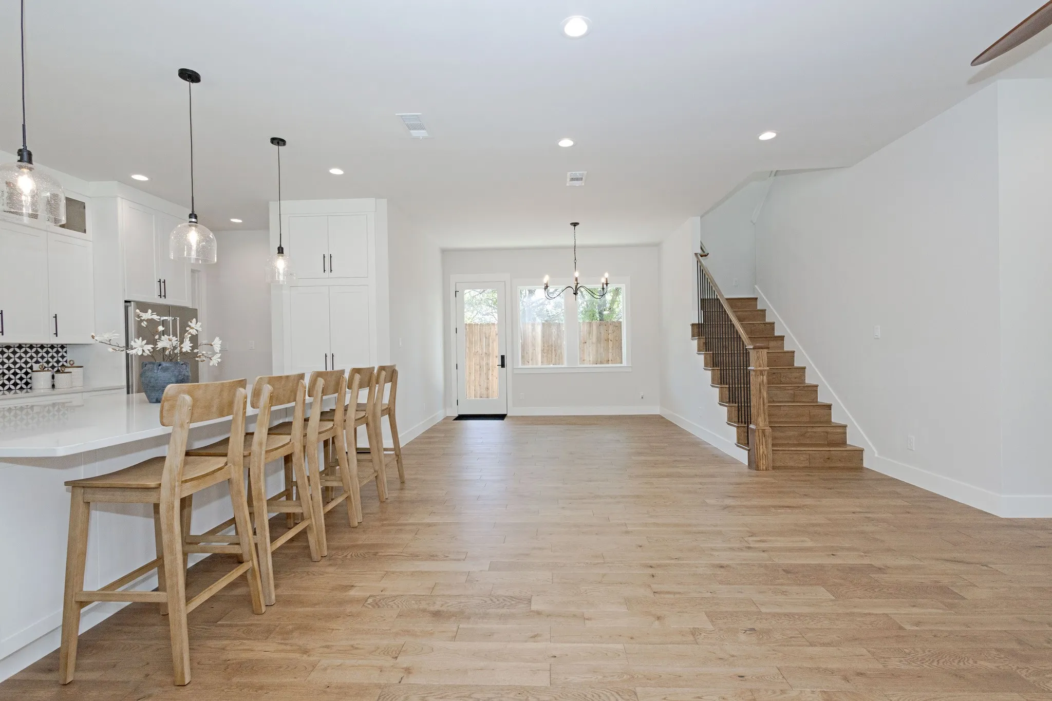 Open, airy Dining Area anchored by a Statement Chandelier.