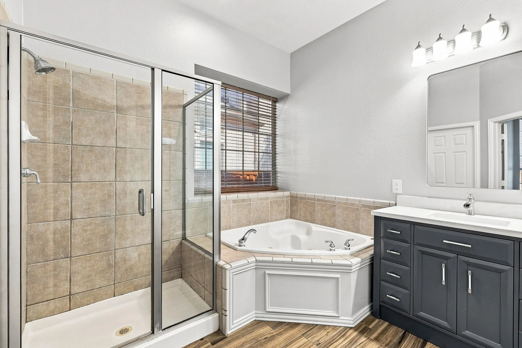 Large walk in shower and separate soaking tub make this space very functional.