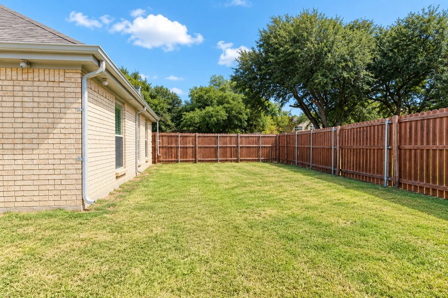 Expansive lawn with a full privacy fence