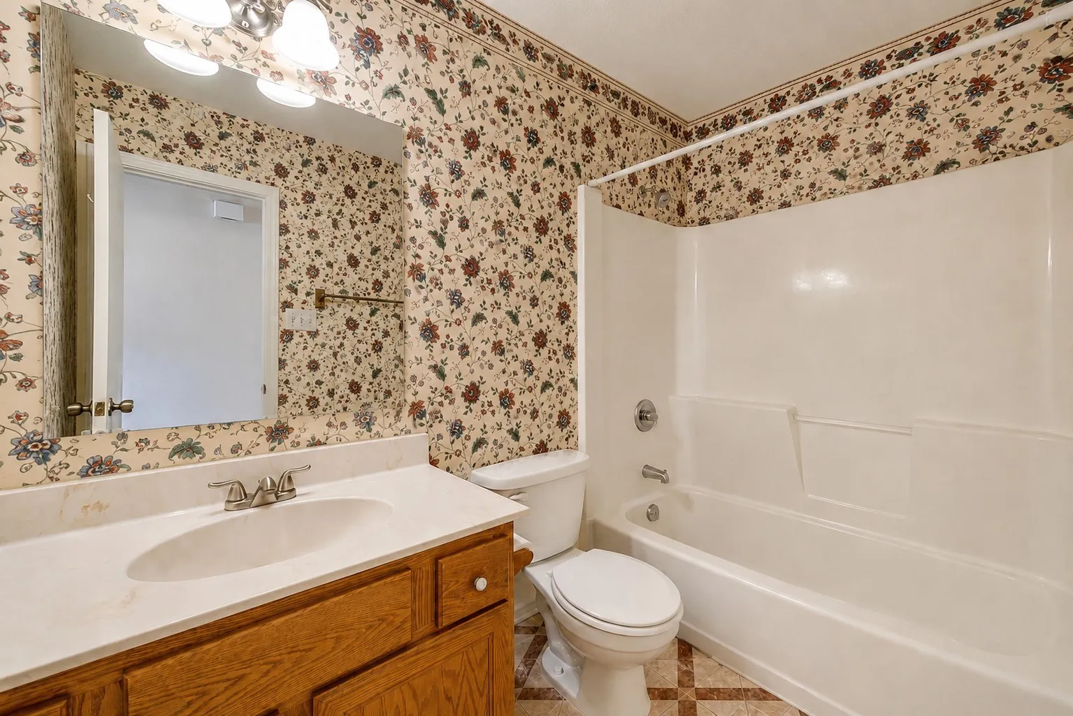 Wood-finish vanity with an integrated sink and chrome faucet
