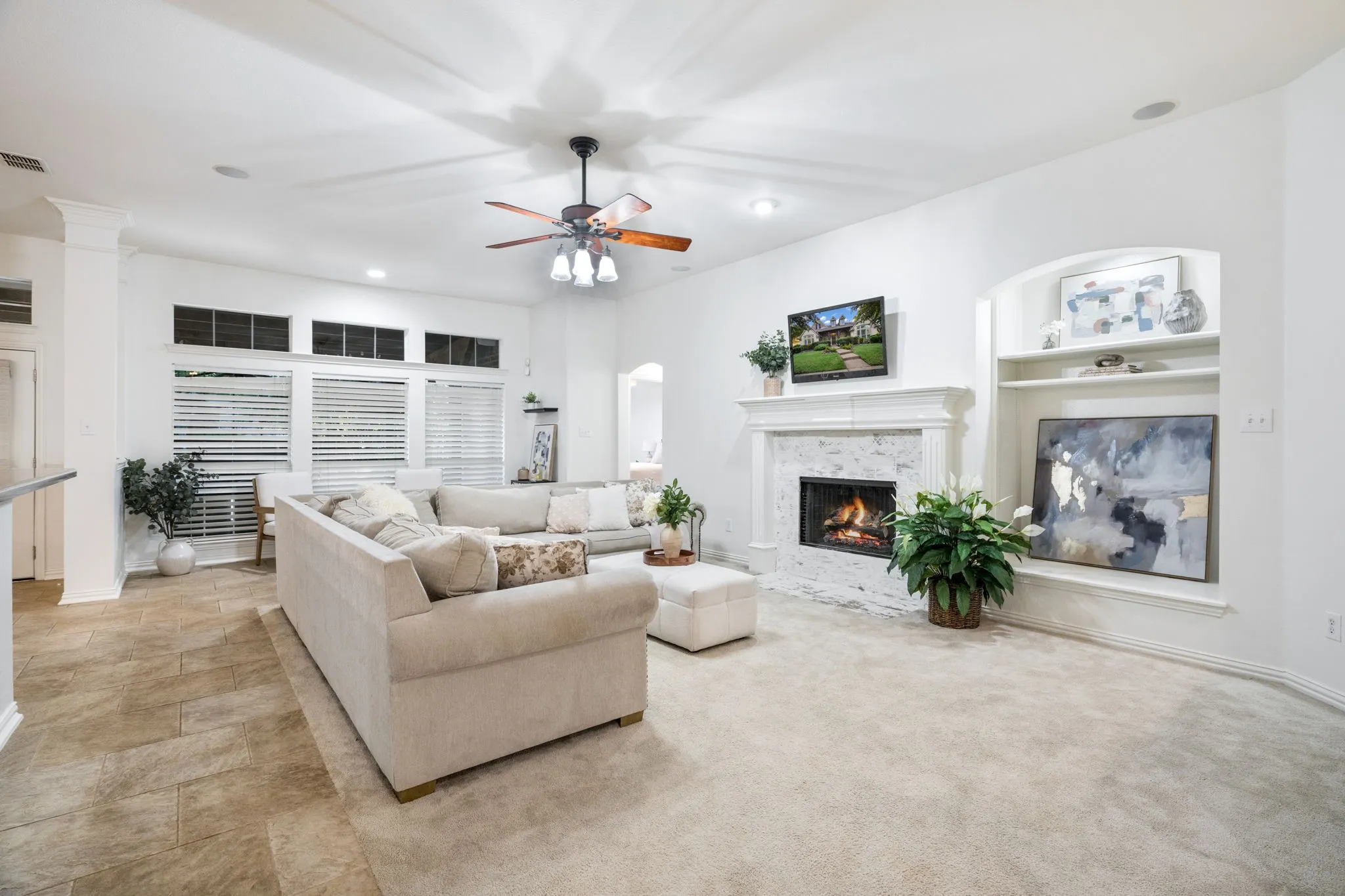 Huge living room with an already Texas sized tall sofa with plenty of spacious room in the living room, a ceiling fan to stay cool and energy efficient, and a fireplace for winter nights. Enjoy additional display space for your travel collections, prized photos, art and showcase your favorite finds! Guess what color is coming back in for design? Beiges and browns! Come put your stamp on it or leave it as it works so well, professionally cleaned and move in ready.