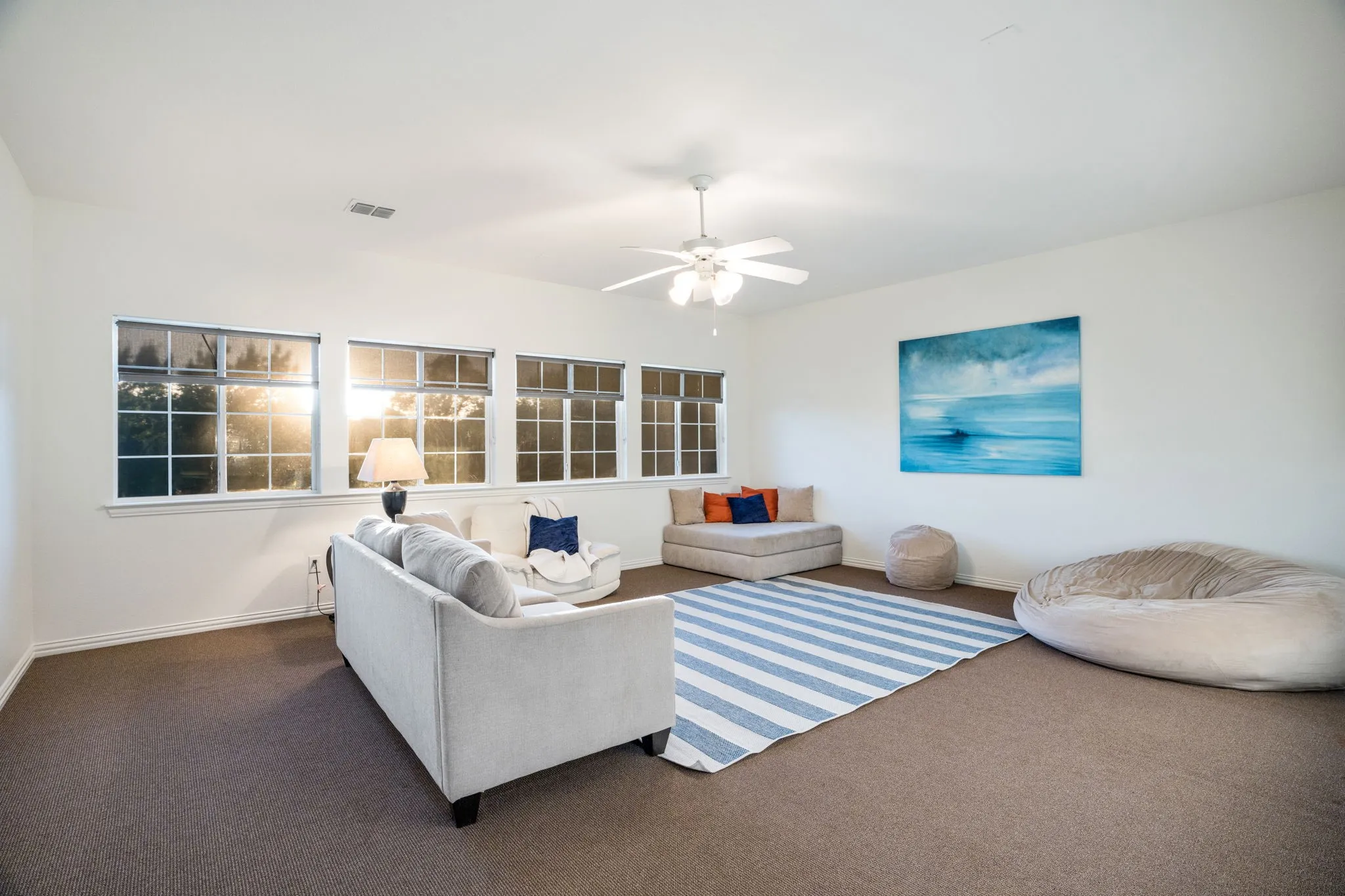 Upstairs golf sim room or huge game room without sacrificing the play area. This game room is expansive and offers an energy efficient light and ceiling fan, lots of windows, and plenty of space to play, most, game, entertain or have a golf simulator!!