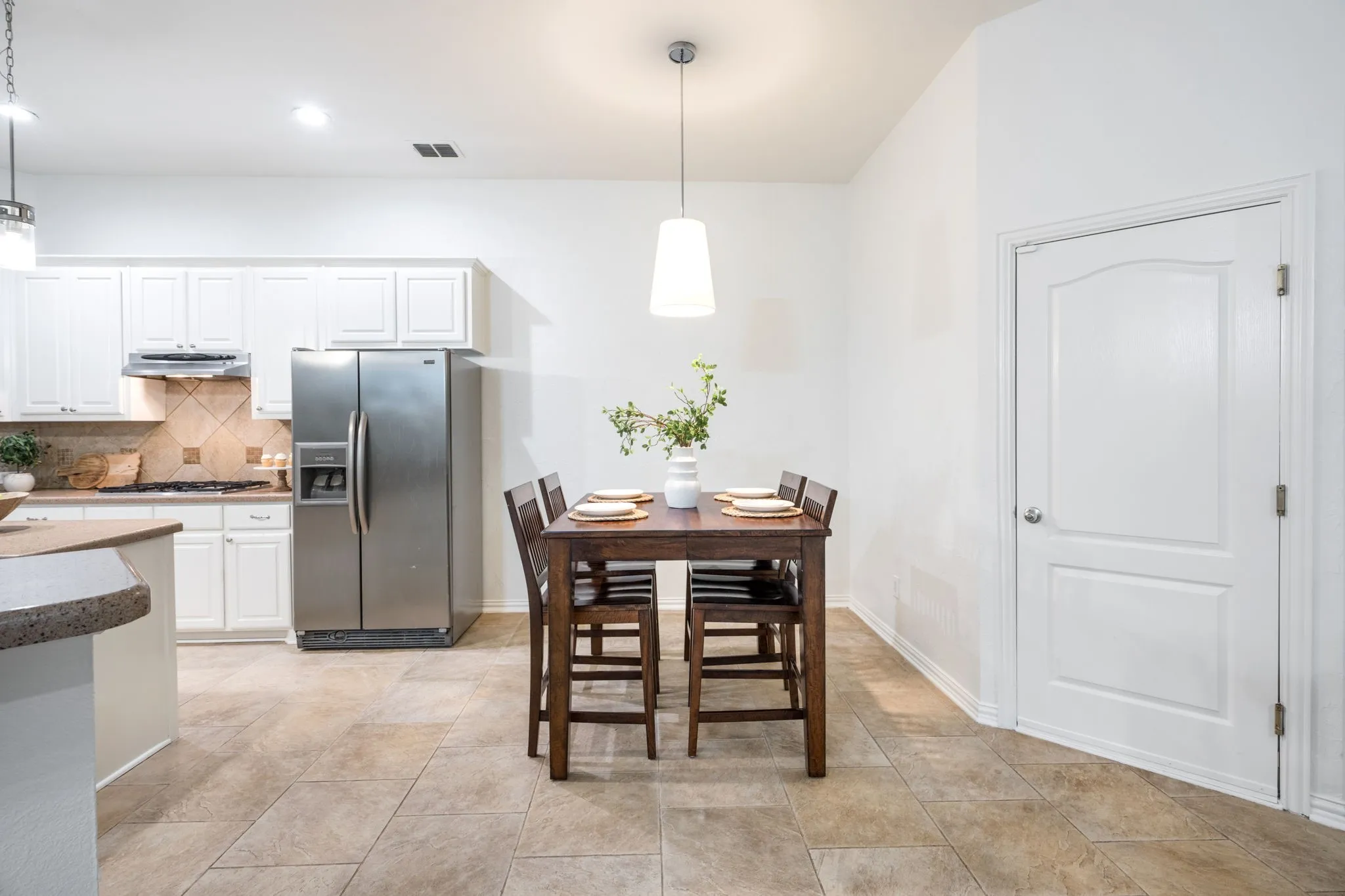 Eat in kitchen nook allows for plenty of room to dine together and host! Plenty of room for exactly the size fridge width you want, this fridge is not coming with this home. Come right in from the garage to the kitchen to unload your Grocery and Costco runs!