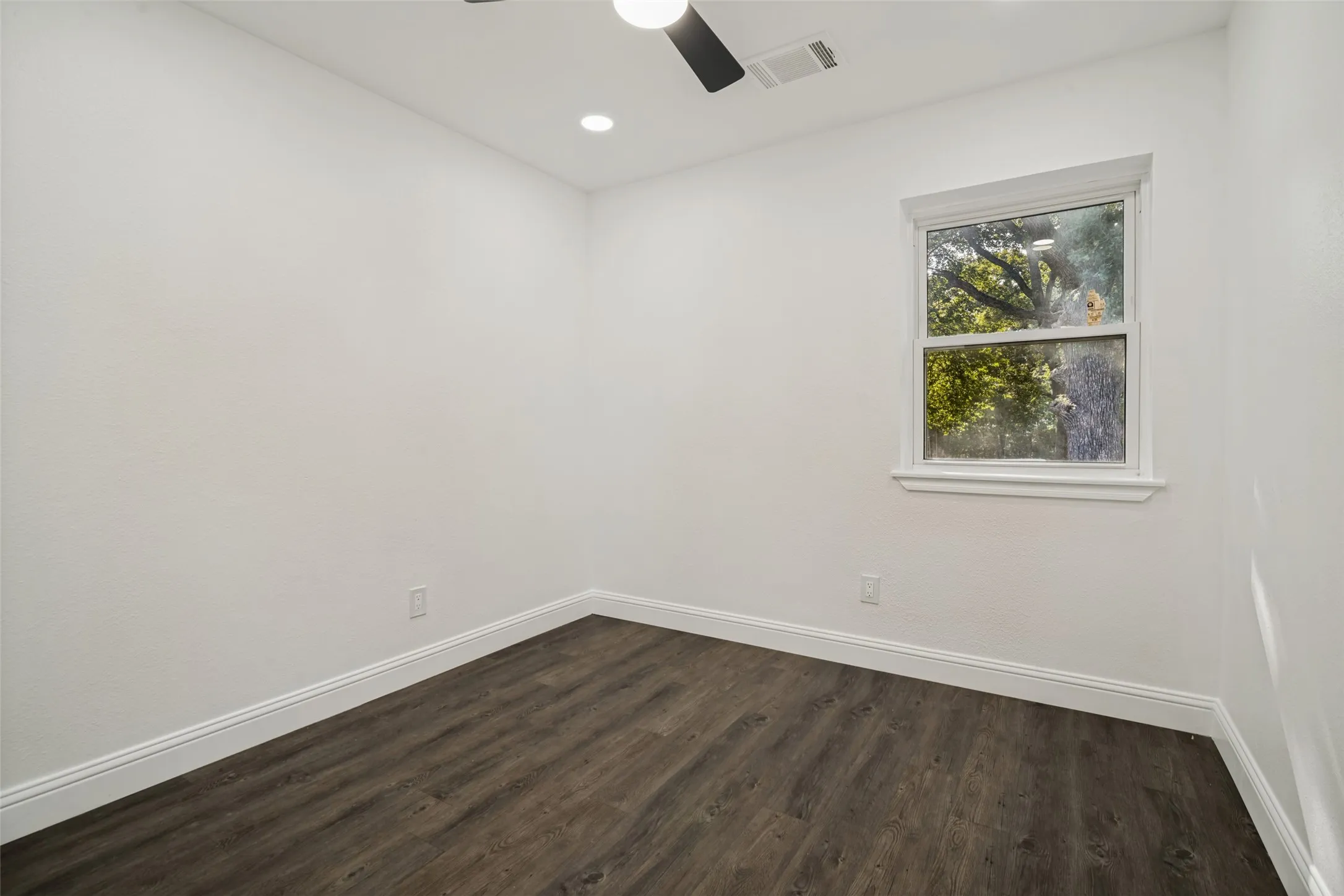 Recessed lighting with a ceiling fan, wood-finish flooring, and white trim