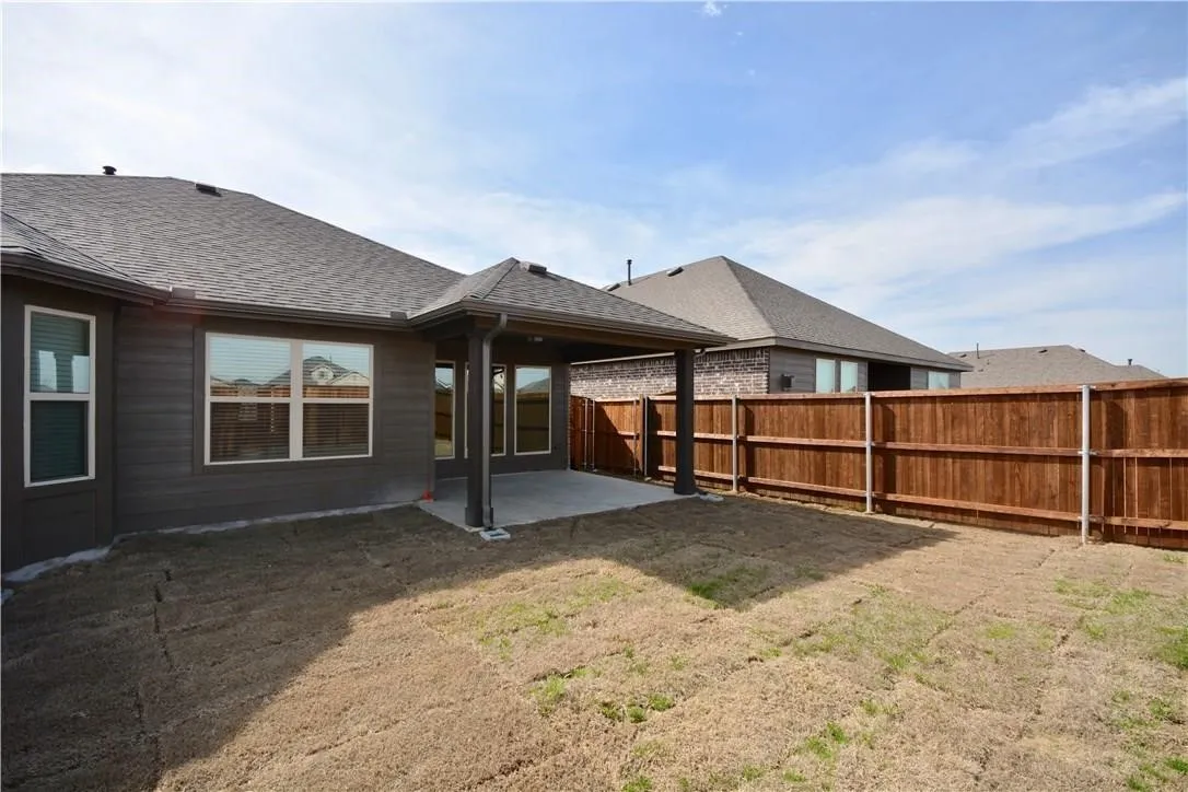 Covered patio with concrete flooring, wood siding exterior, and shingle roofing