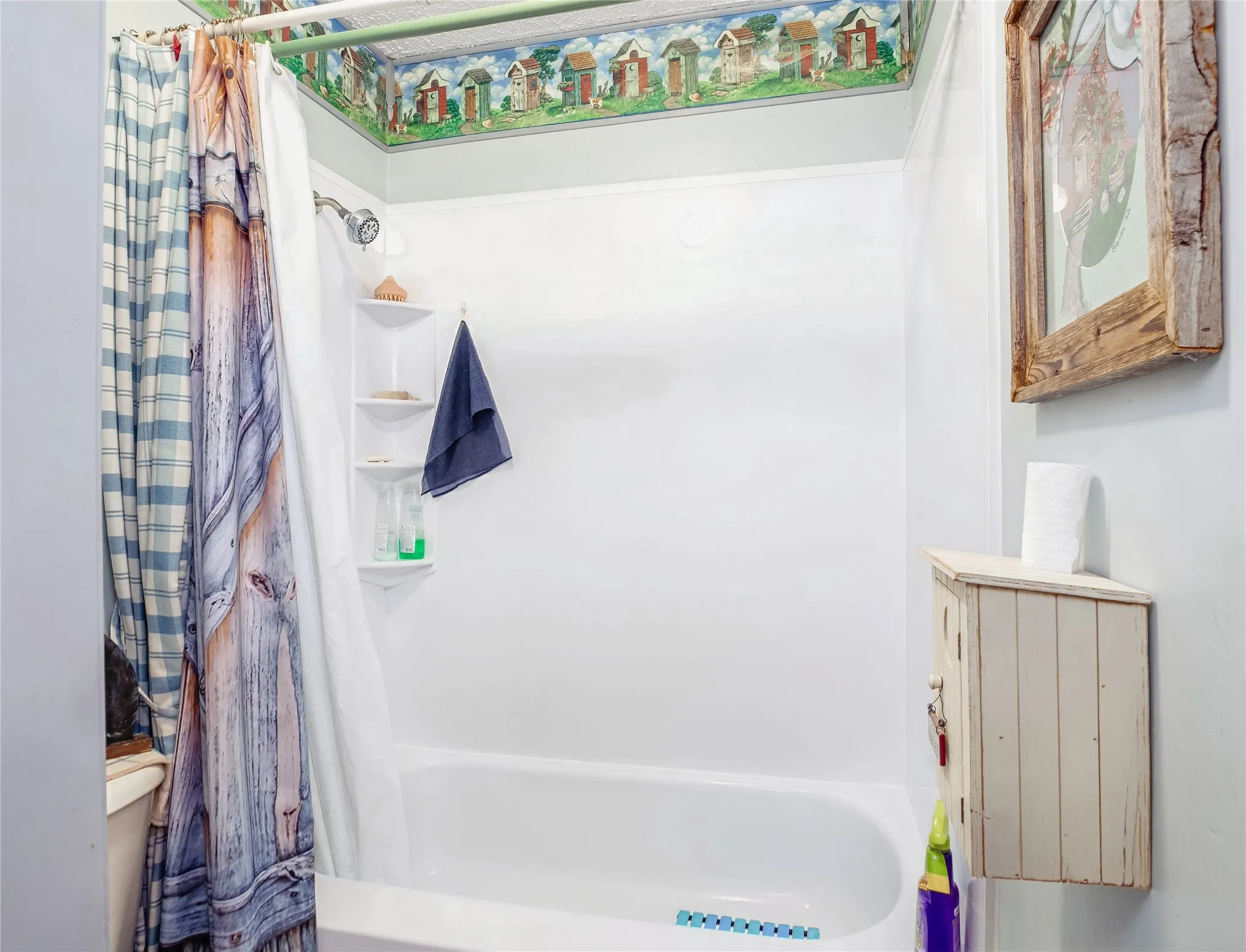 Tub and shower combination with an integrated multi-tier corner shelf