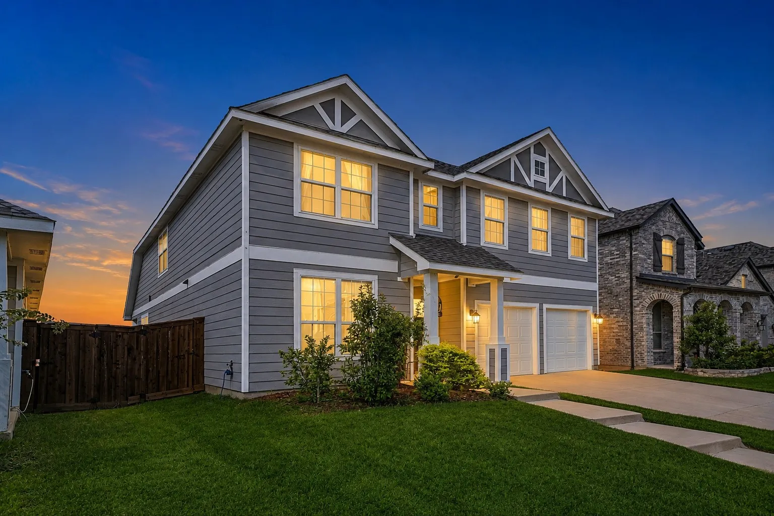 Two-story residential structure featuring horizontal siding and decorative gables