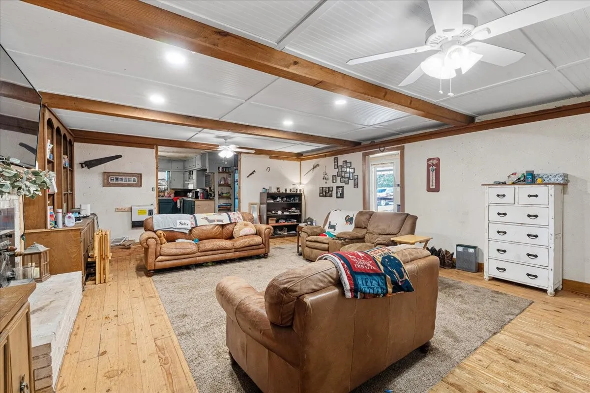 Exposed ceiling beams, wood-finish flooring, and recessed lighting