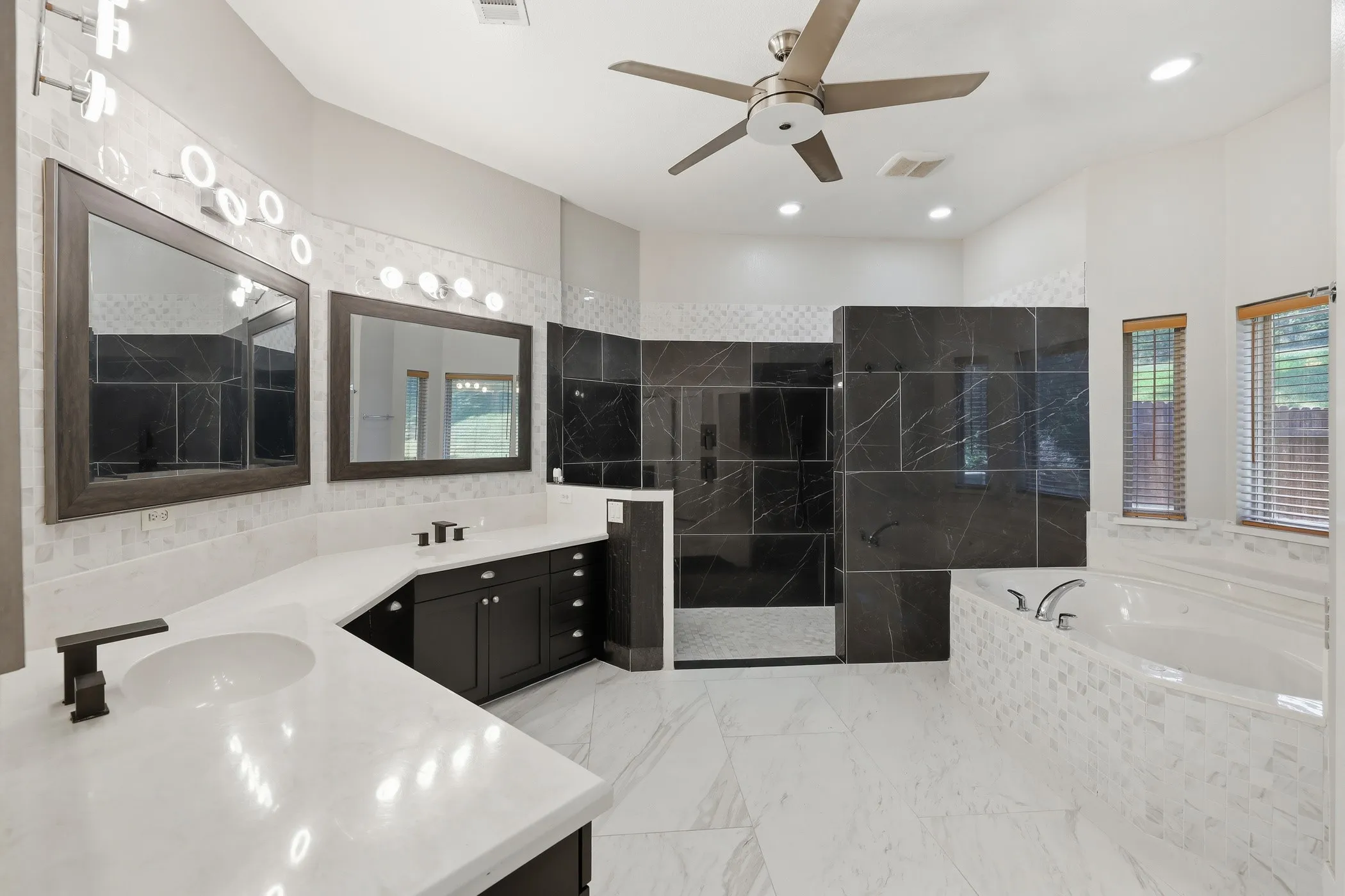 Dual vanity with dark wood cabinetry and white countertops