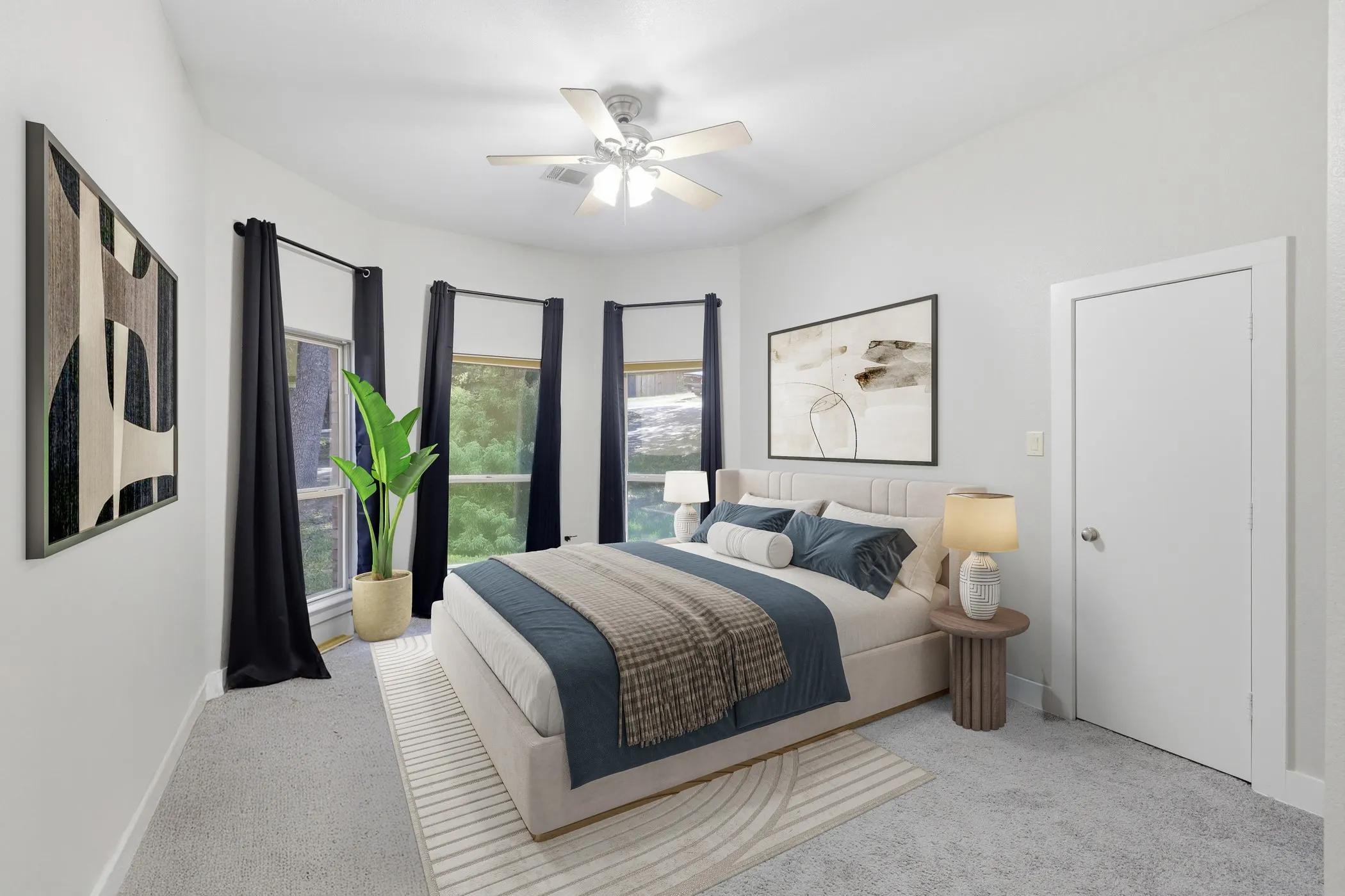 Vaulted ceiling with a ceiling fan, three large windows, light gray carpeting, and a white interior door