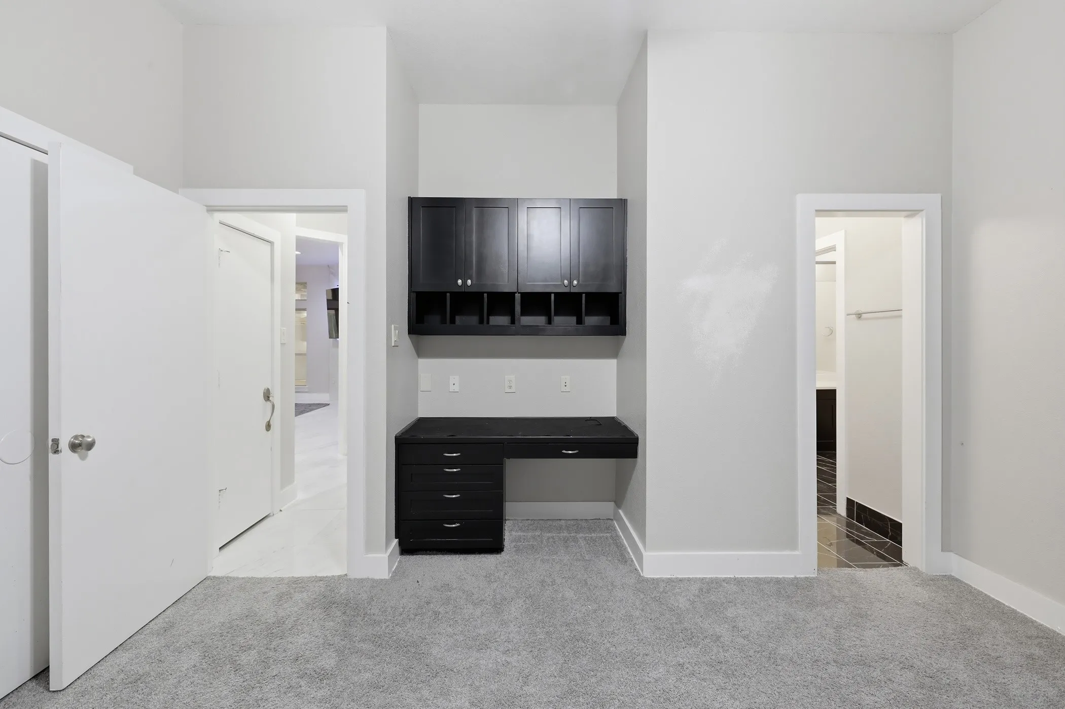 Built-in desk with dark wood cabinetry and integrated storage